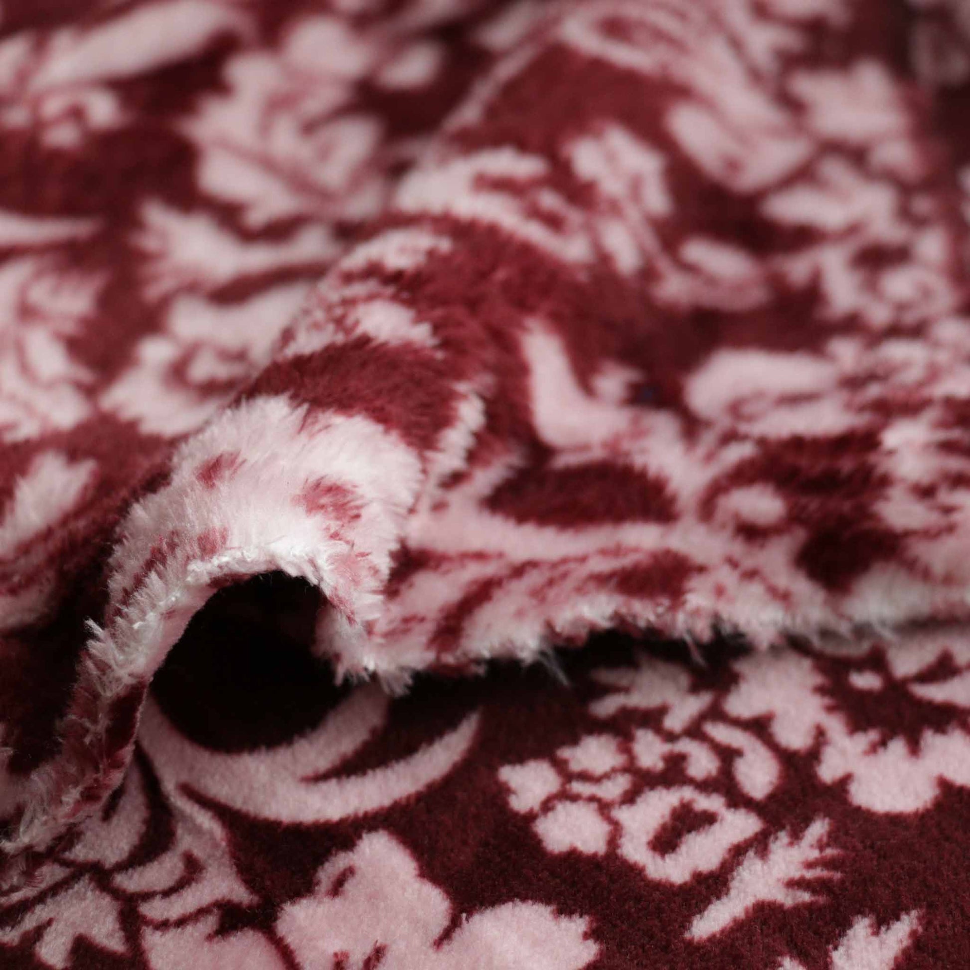 maroon fleece dressmaking fabric with pale pink classical flower print