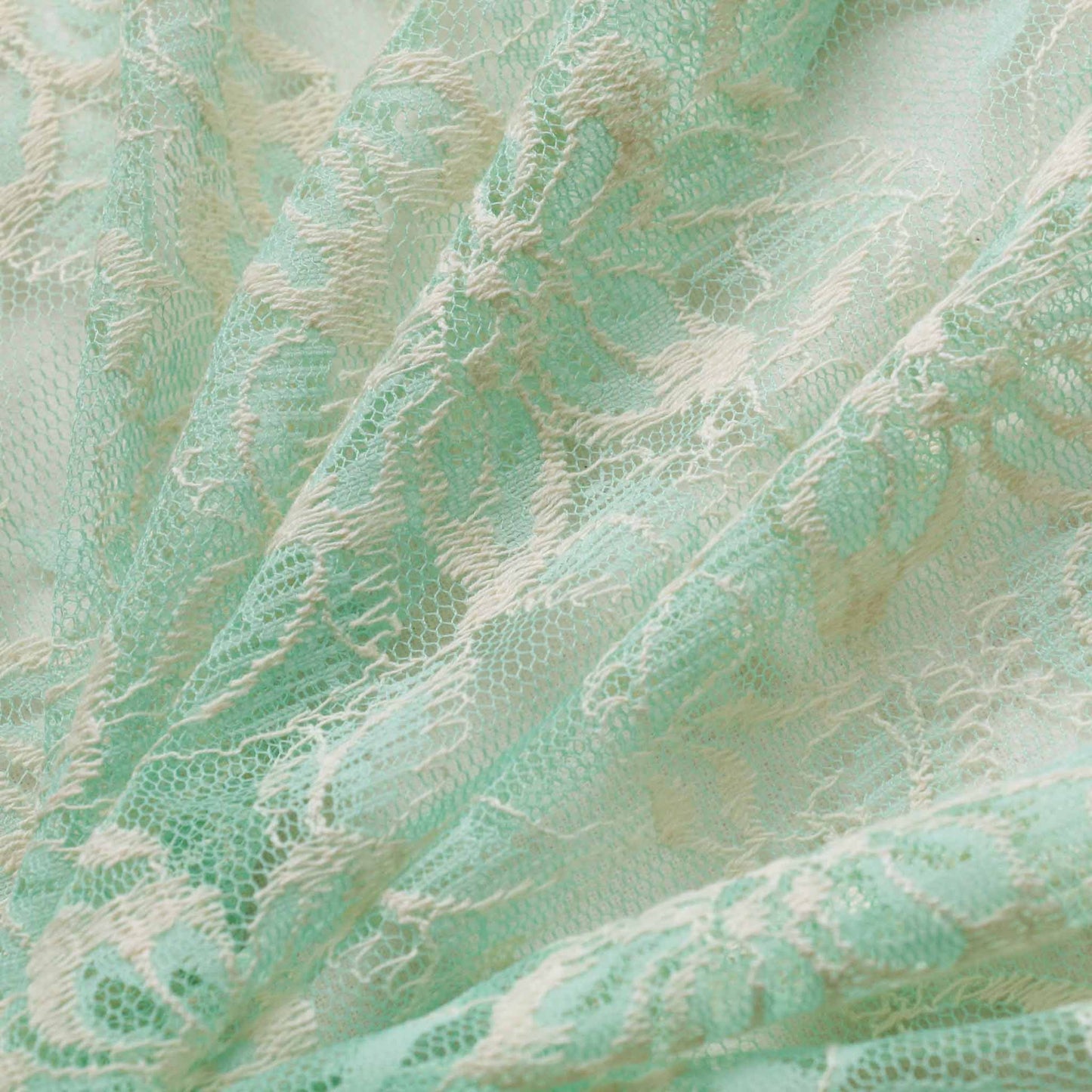 floral dressmaking lace fabric in cool mint and cream with floral delicate pattern