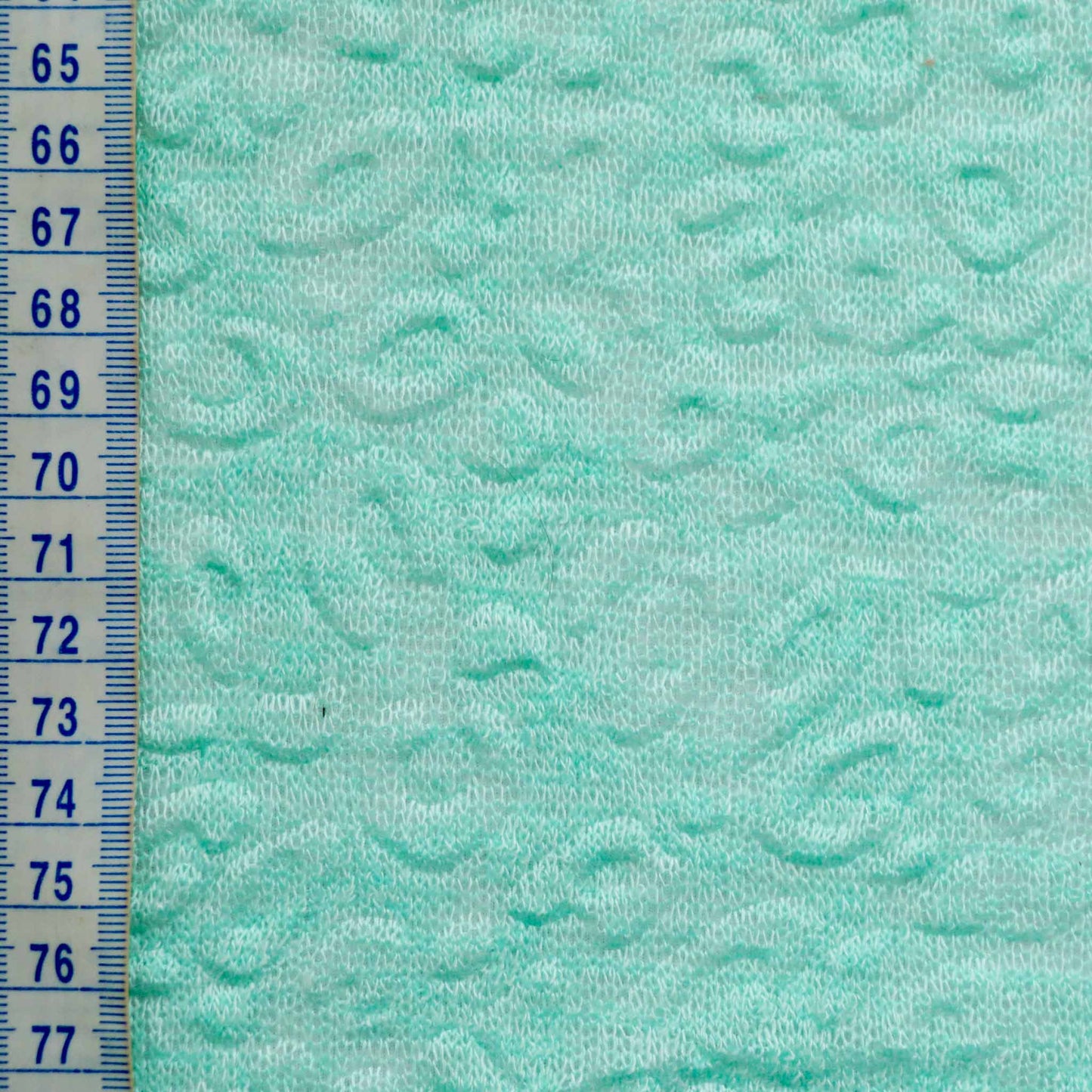 metre mint coloured jersey knit dressmaking fabric with embossed decorative texture
