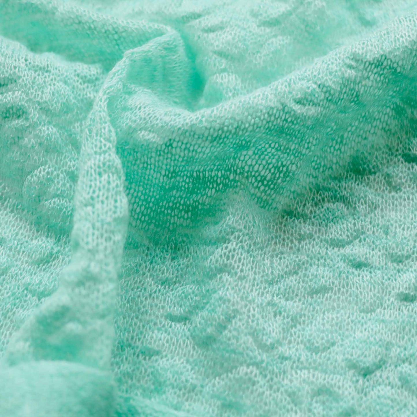 decorative embossed jersey knit dressmaking fabric in mint green