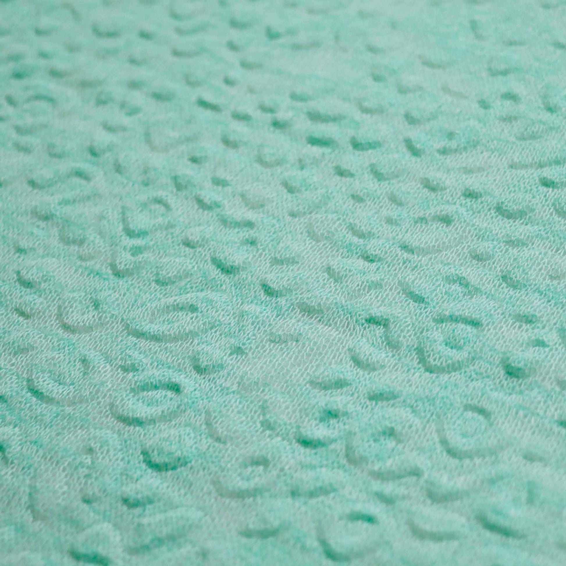 embossed mint green jersey knit fabric with decorative texture effect