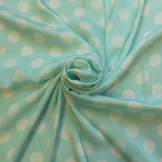 mint satin twill dressmaking fabric with polka dot design