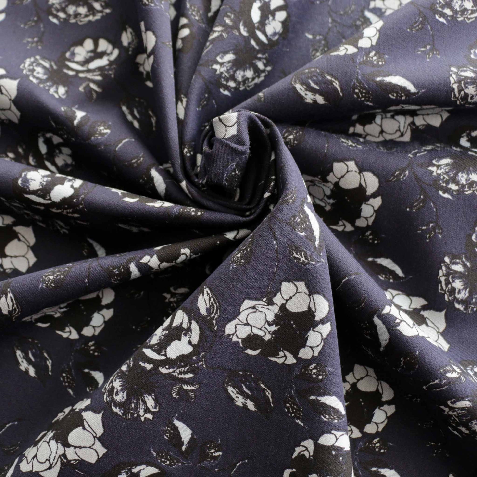 black and white floral print on navy blue cotton sateen dressmaking fabric