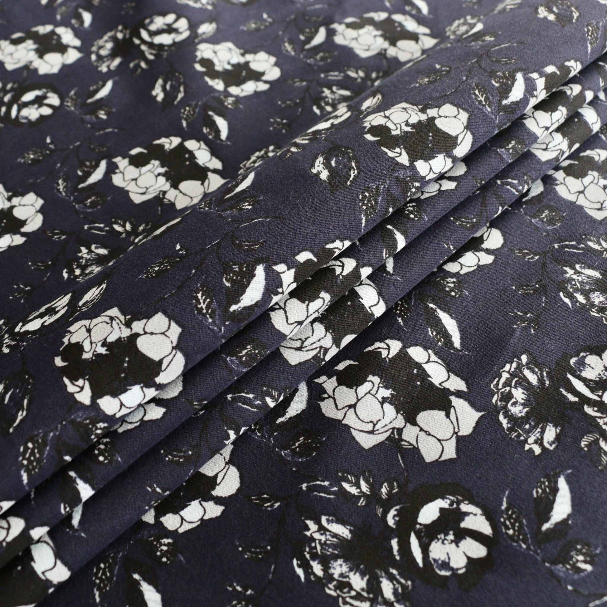navy blue folded cotton sateen dress fabric with white and black flowers printed