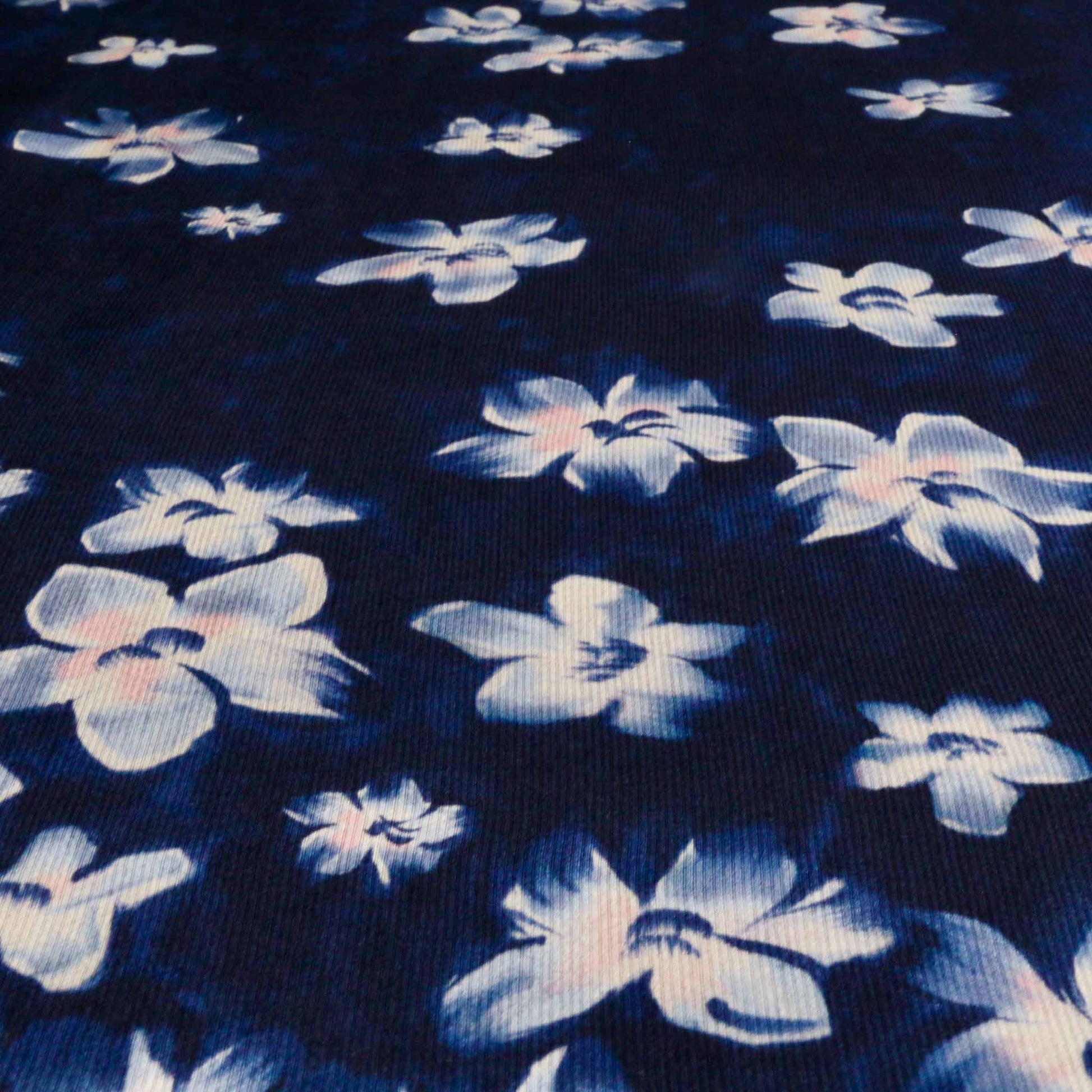 crepe back satin dressmaking fabric in navy blue with white floral print