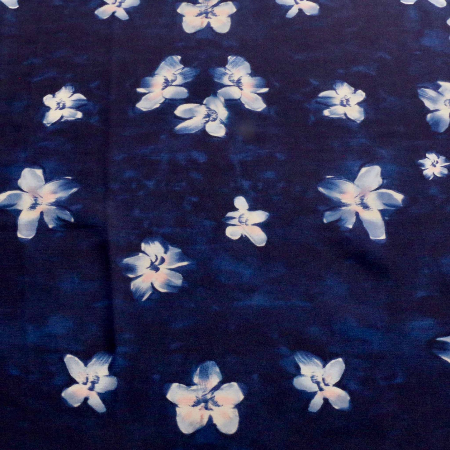 floral crepe back satin dressmaking fabric in navy blue with white floral print