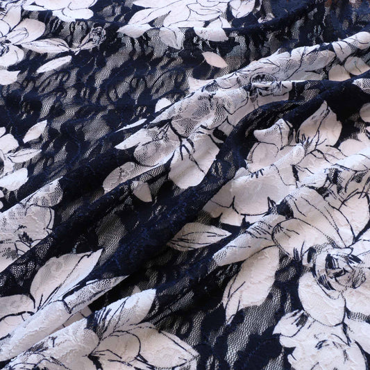 navy lace dressmaking fabric with large white floral pattern