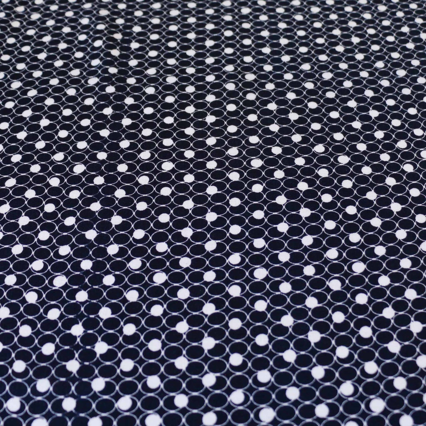 navy blue viscose challis dressmaking rayon fabric with white geometric circle printed design