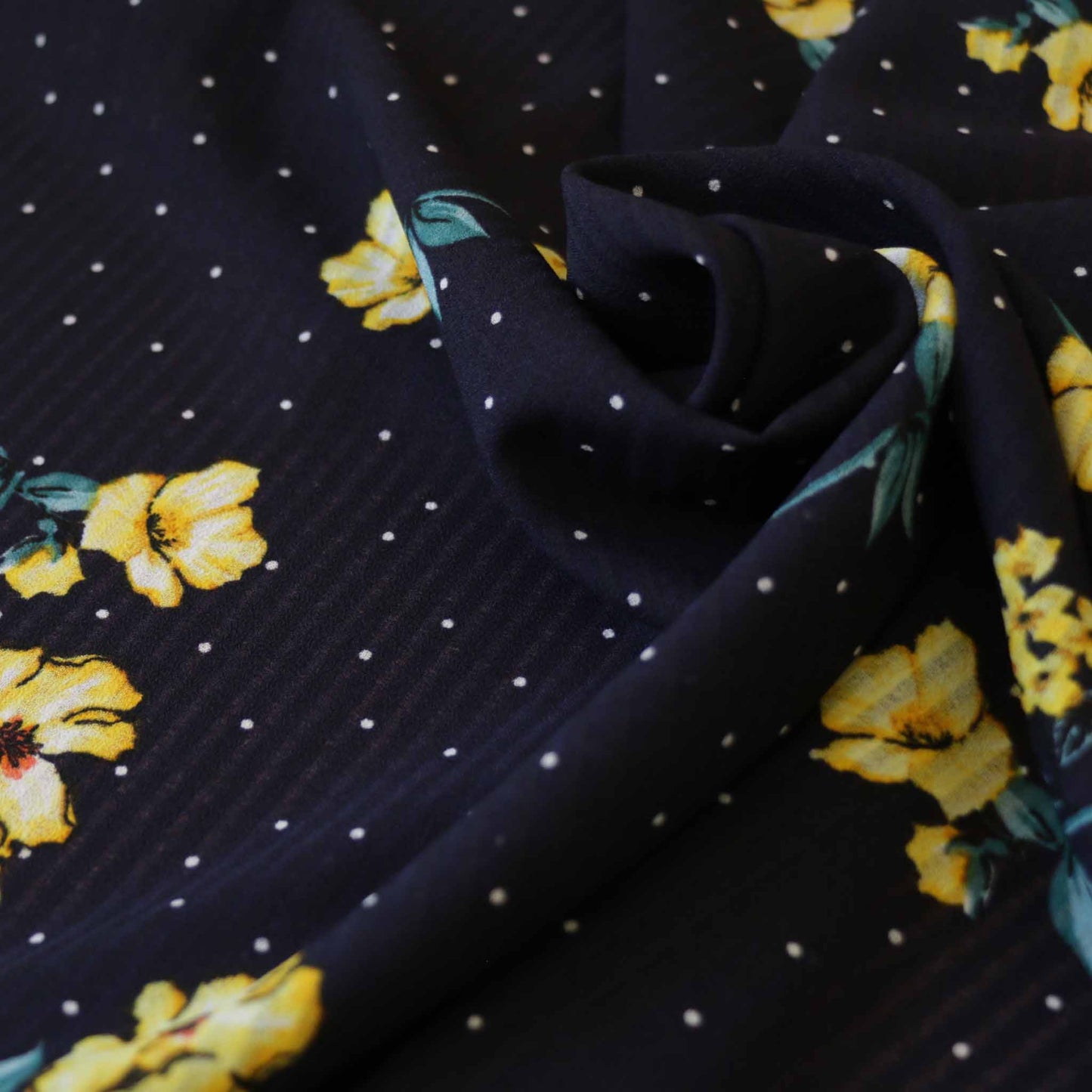 yellow flower print on navy blue georgette dressmaking fabric with polka dots
