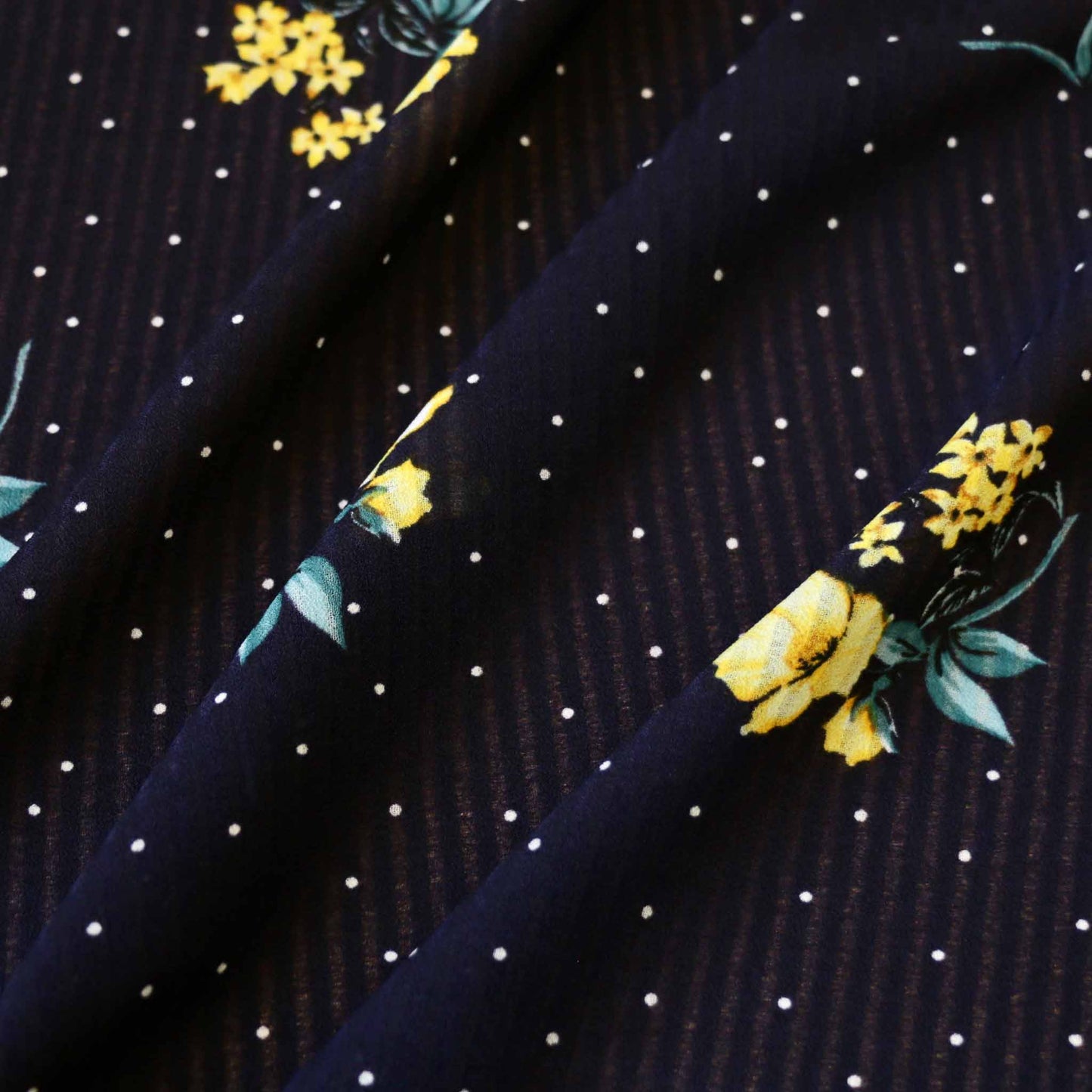 polka dot and floral print on navy blue georgette fabric with yellow flowers