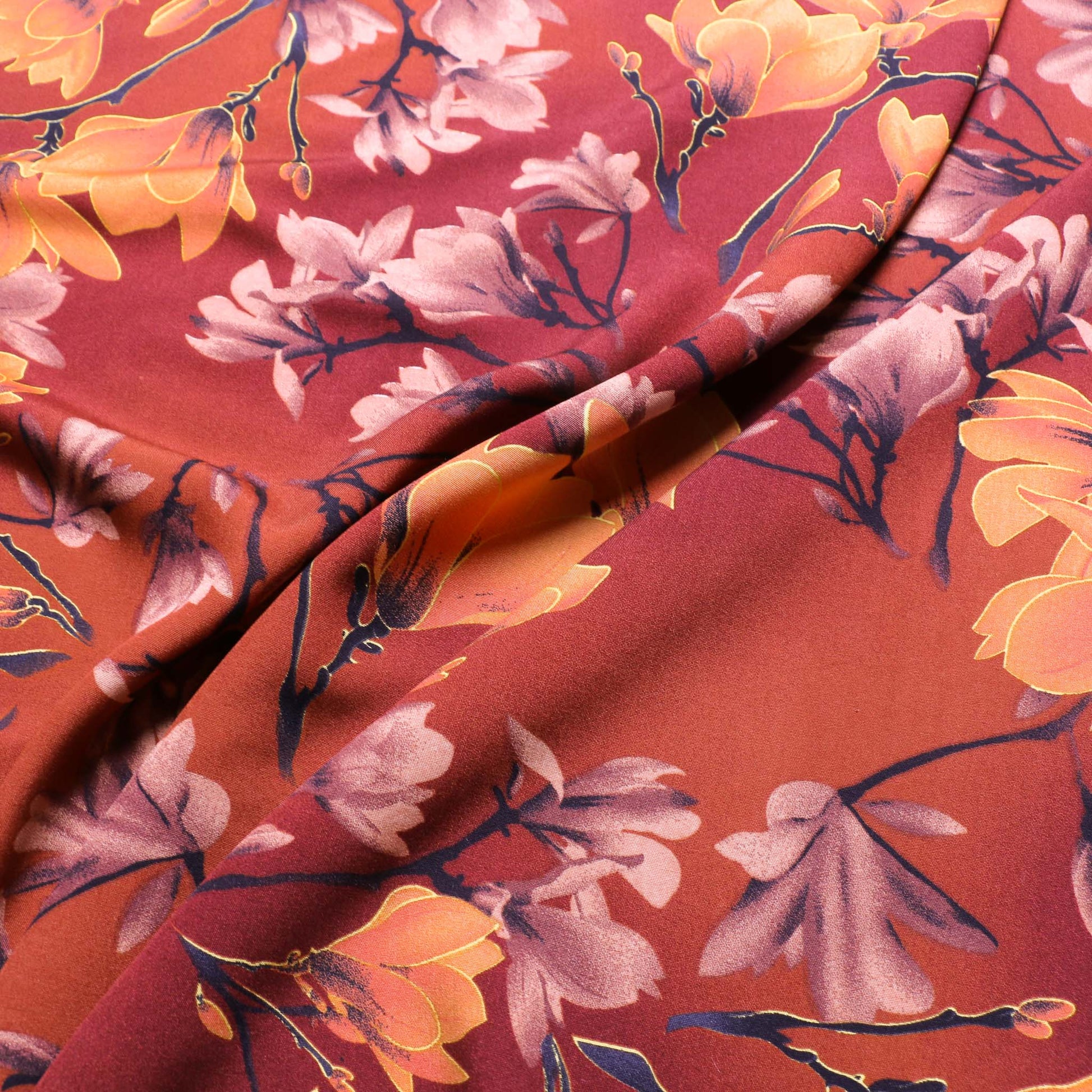 burnt orange viscose challis dressmaking fabric with floral print