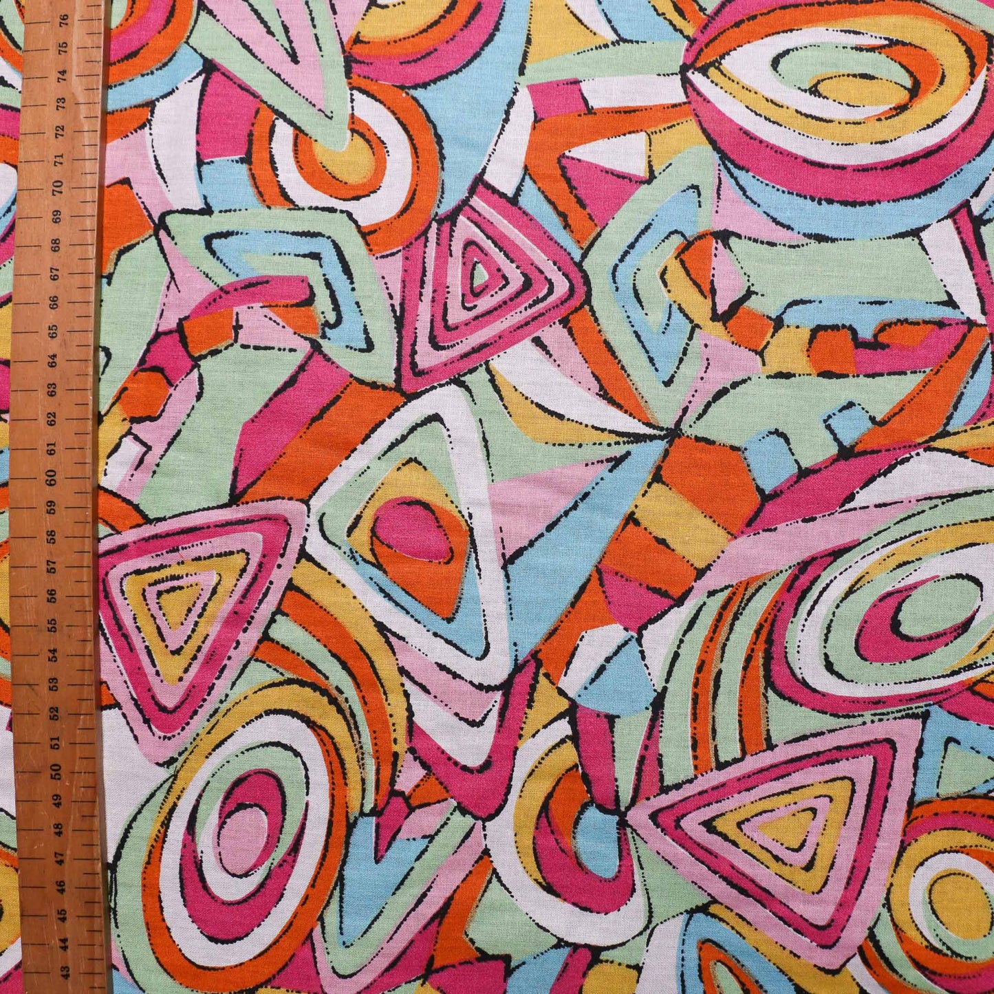 metre pink orange sustainable retro cotton dressmaking fabric with abstract design