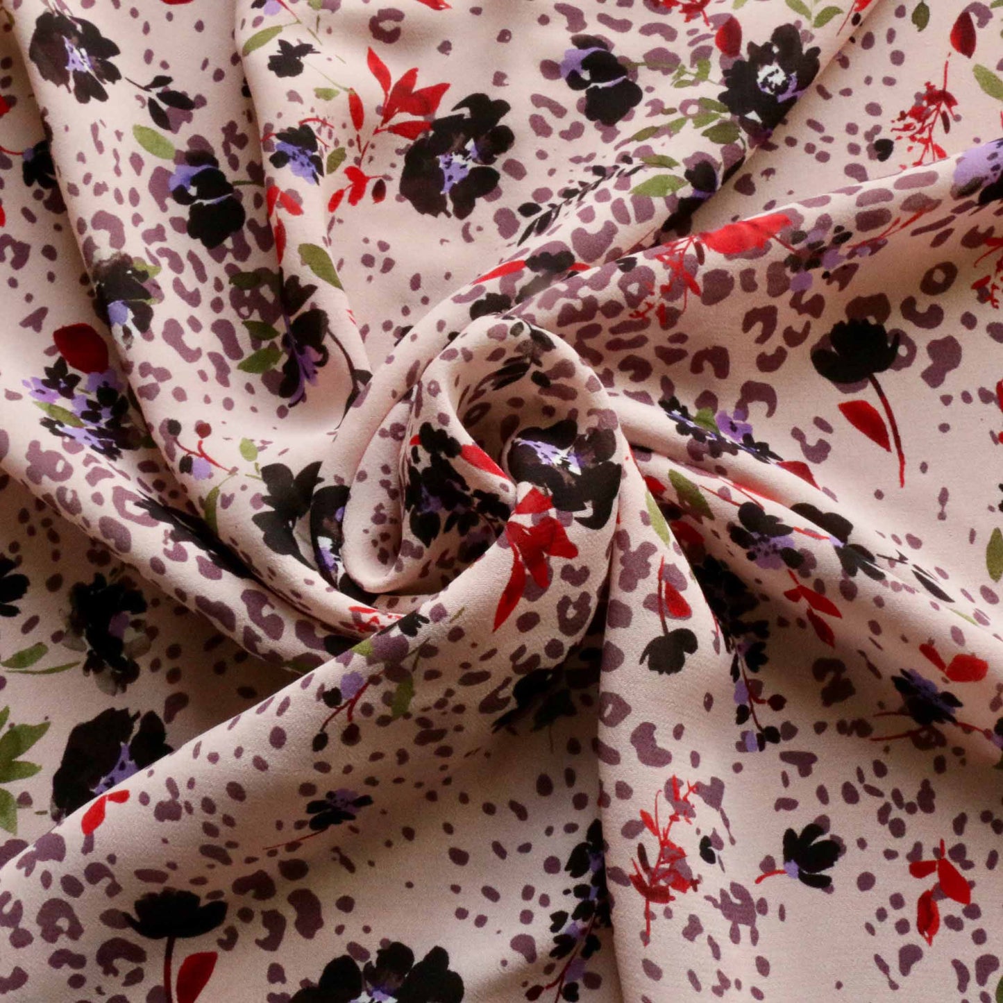 pink chiffon viscose dressmaking fabric with flowers and animal print in black and brown
