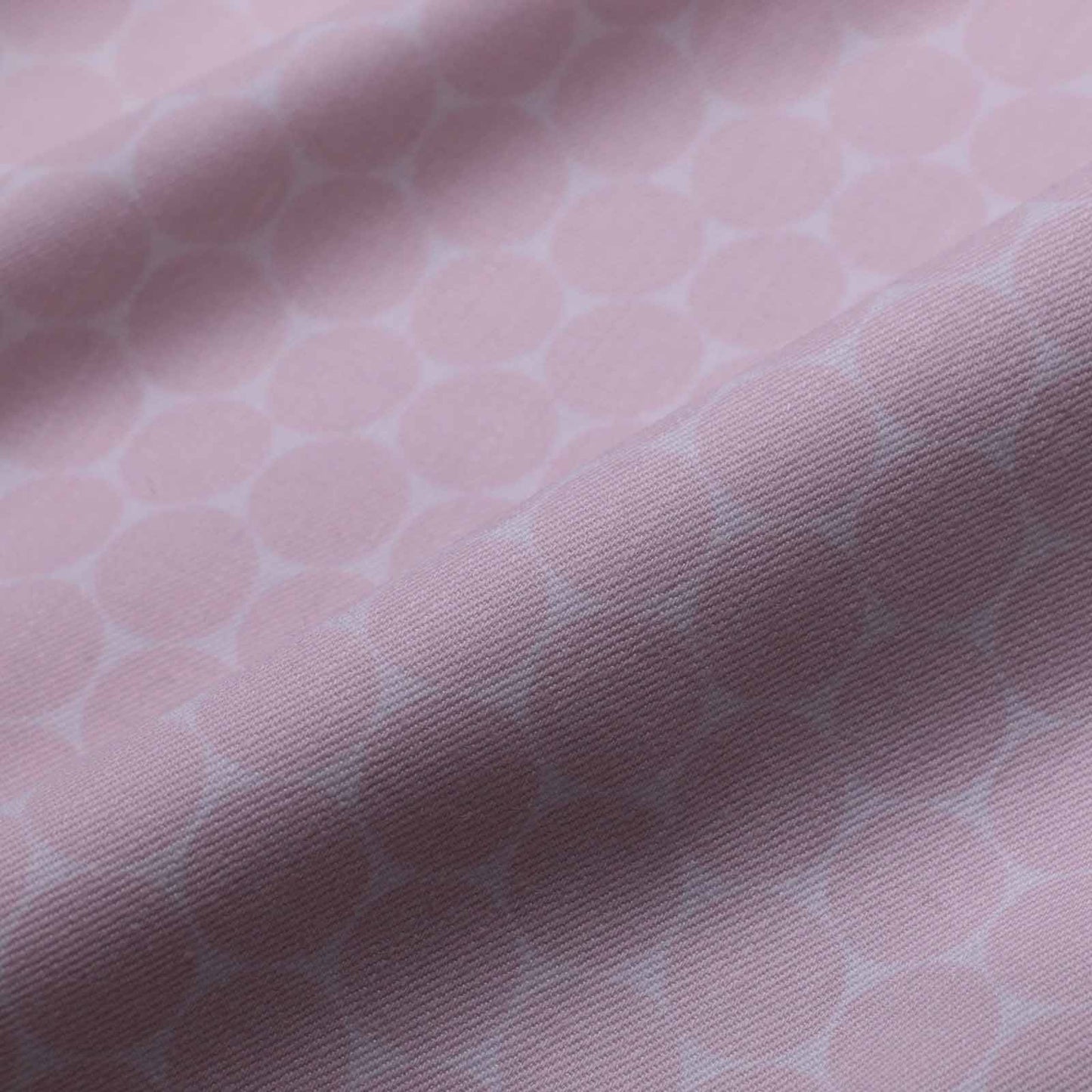 folded pink and white dot pattern stretchy cotton twill dressmaking fabric