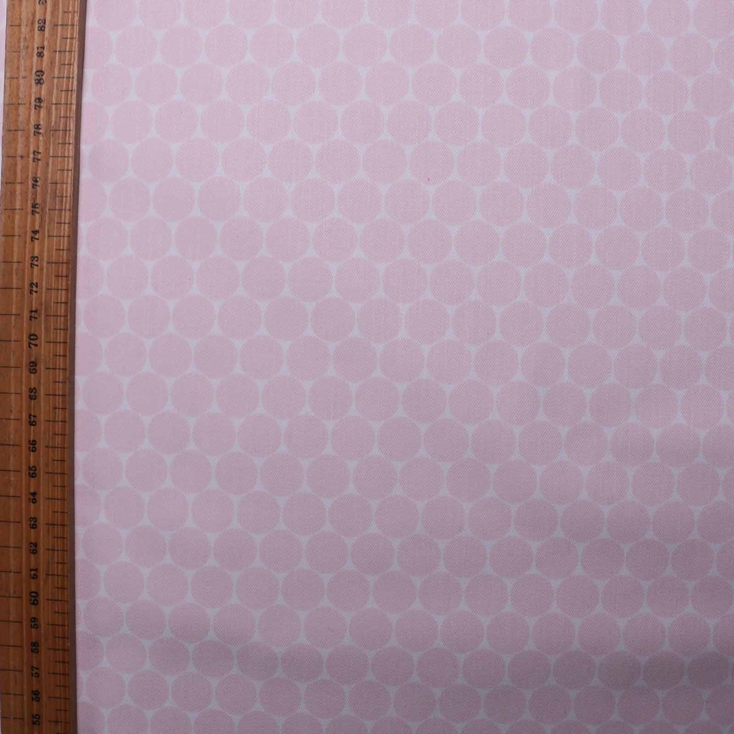 metre stretchy cotton twill dressmaking fabric with pale pink and white dot design