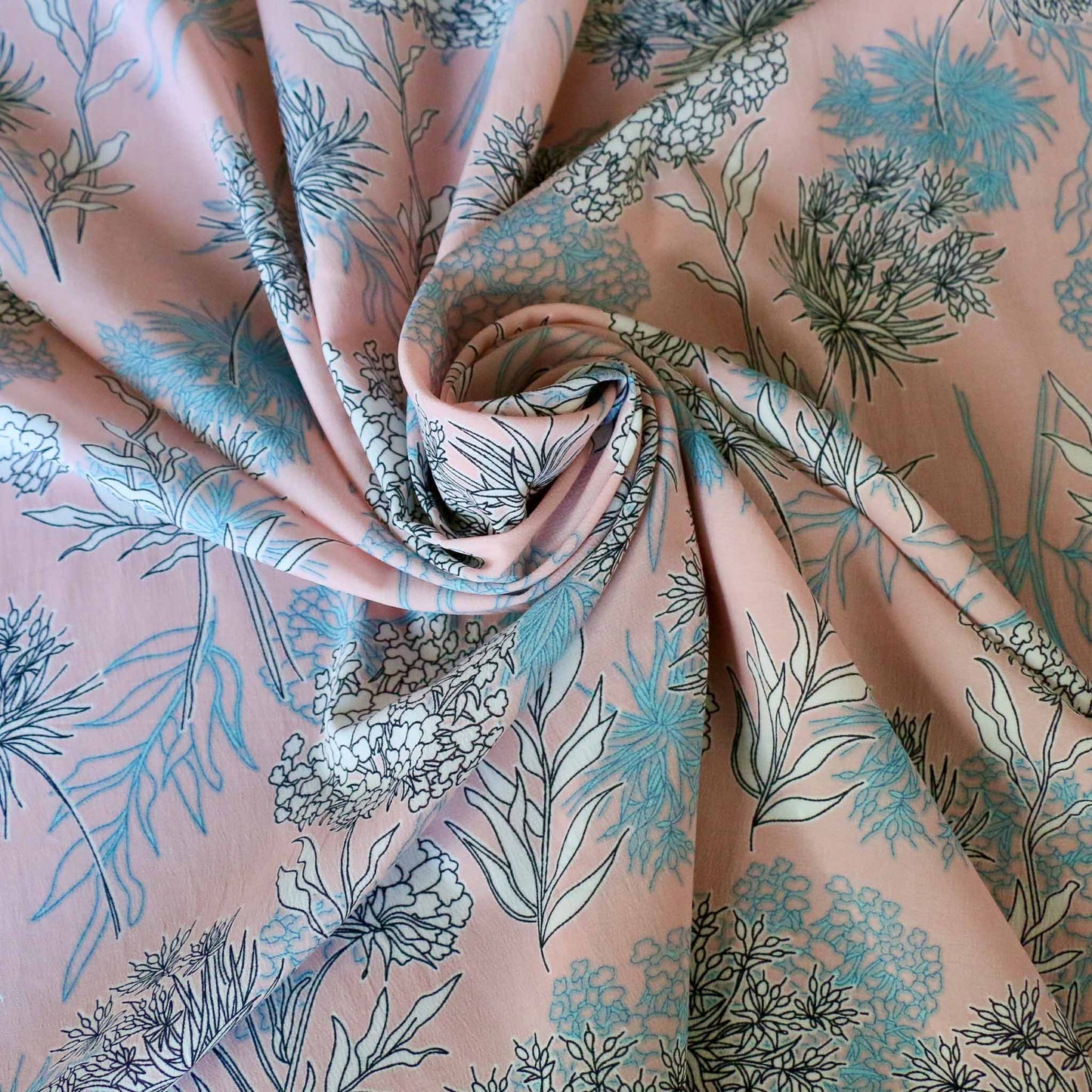 stretchy chiffon polyester dressmaking fabric in pink with white and blue floral print