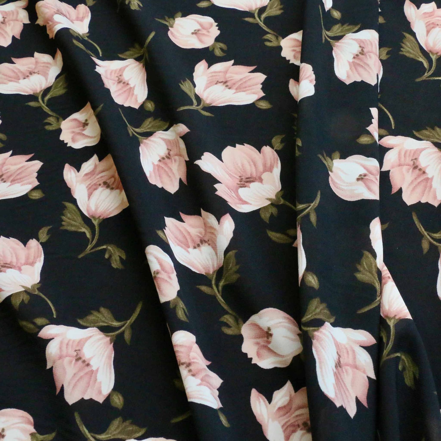 pink flowers printed on black chiffon polyester dressmaking fabric