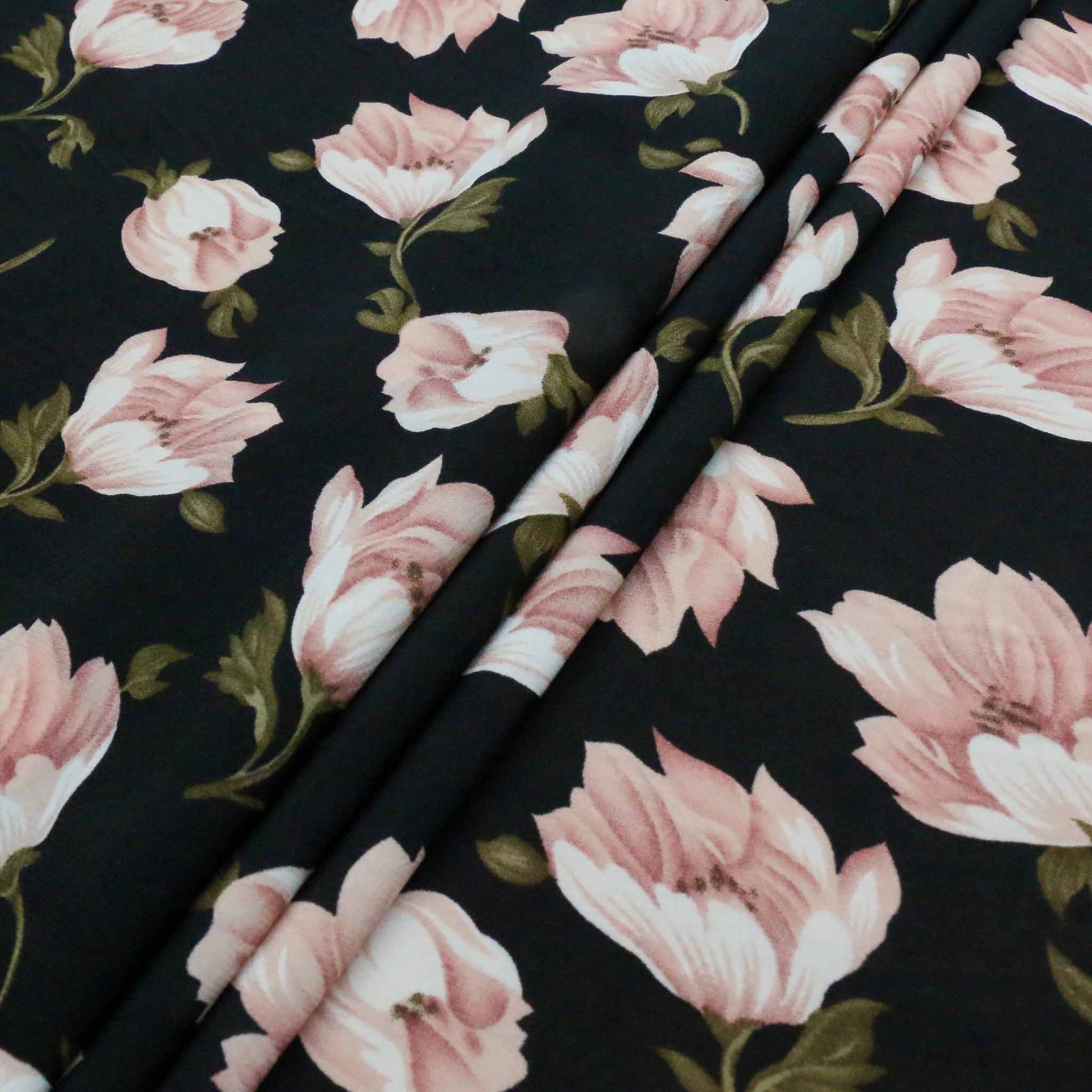 folded black chiffon polyester dressmaking fabric with pink printed flowers