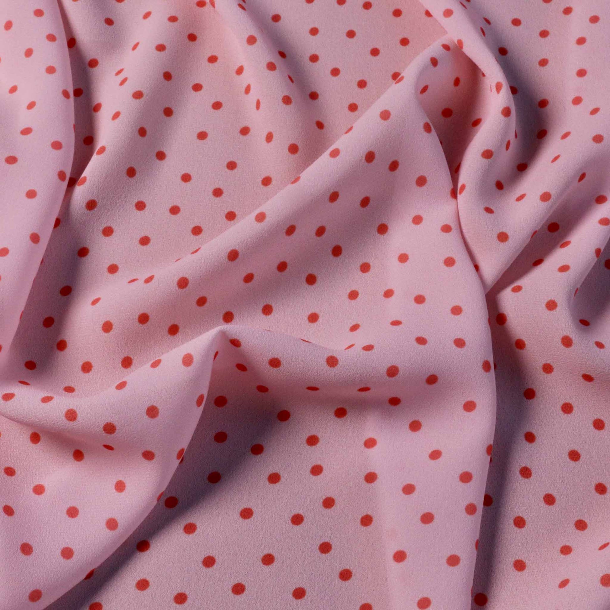 polka dots design in pink georgette dressmaking fabric