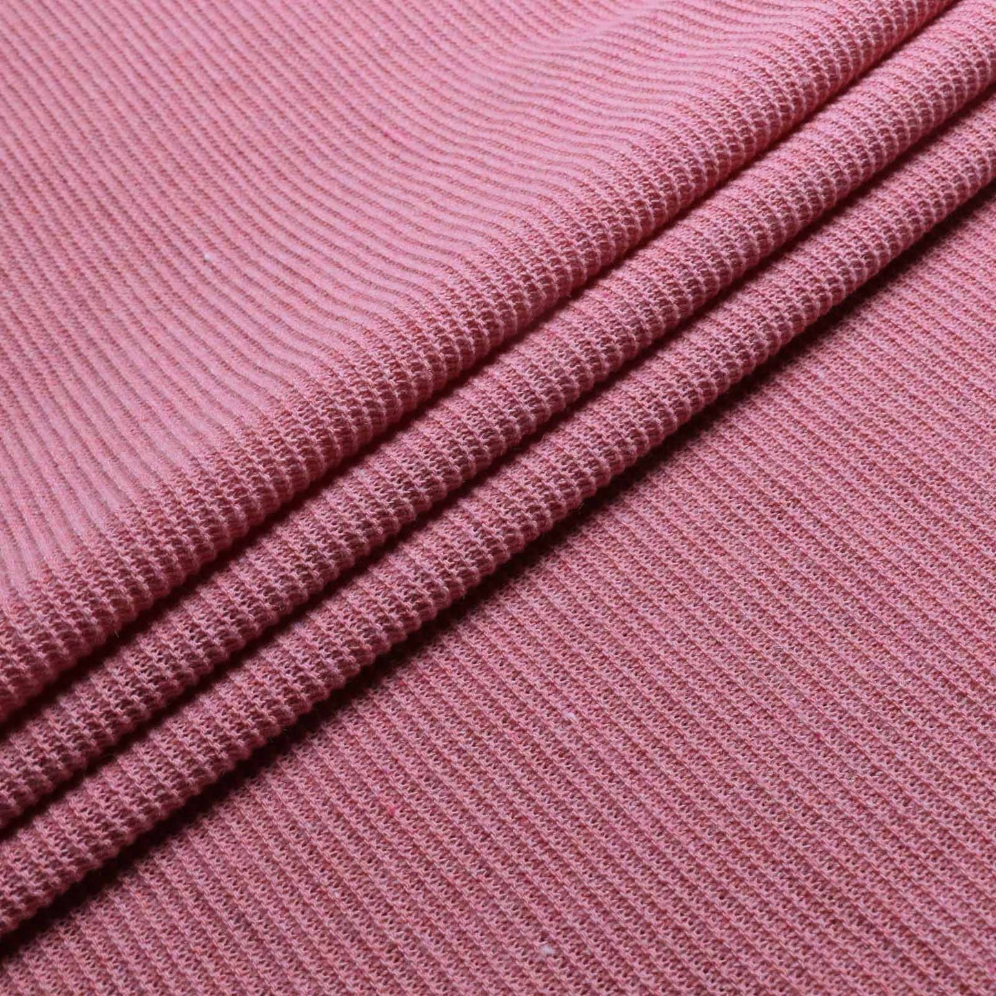 folded dusty pink purl wool jersey knit dressmaking fabric