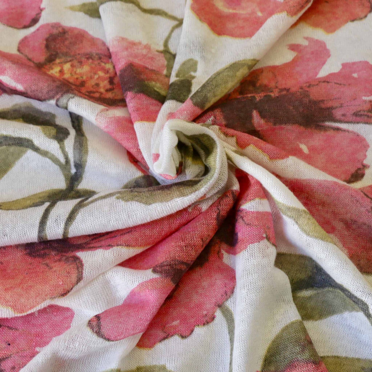pink flowers printed on white linen jersey fabric for dressmaking