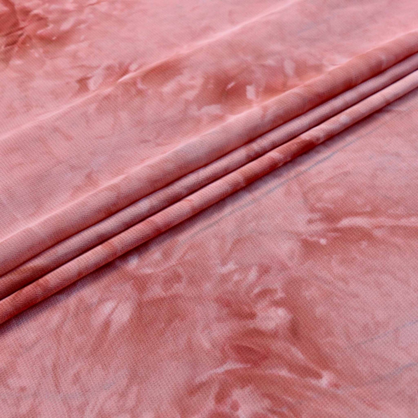 chiffon polyester dressmaking fabric in pink marble effect colour