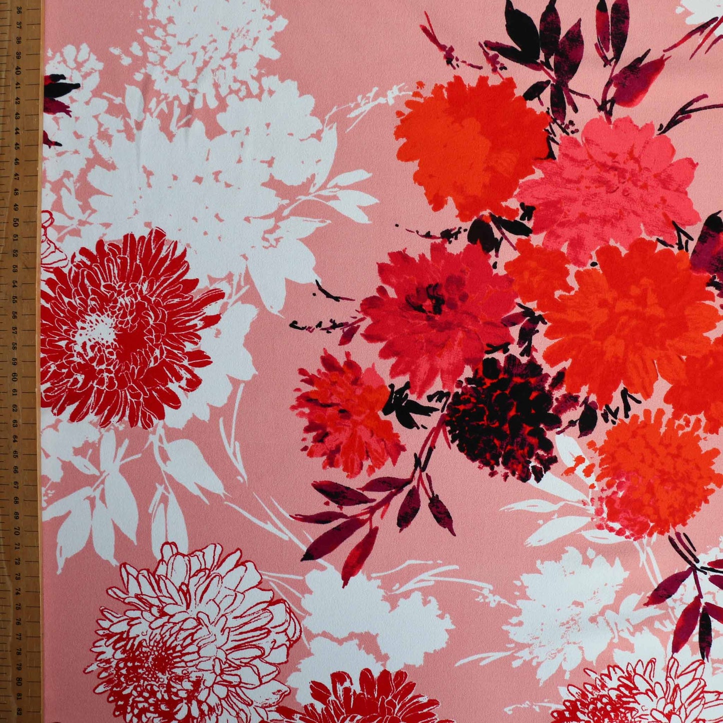 metre john kaldor fabric for dressmaking with pink background and red and white flowers