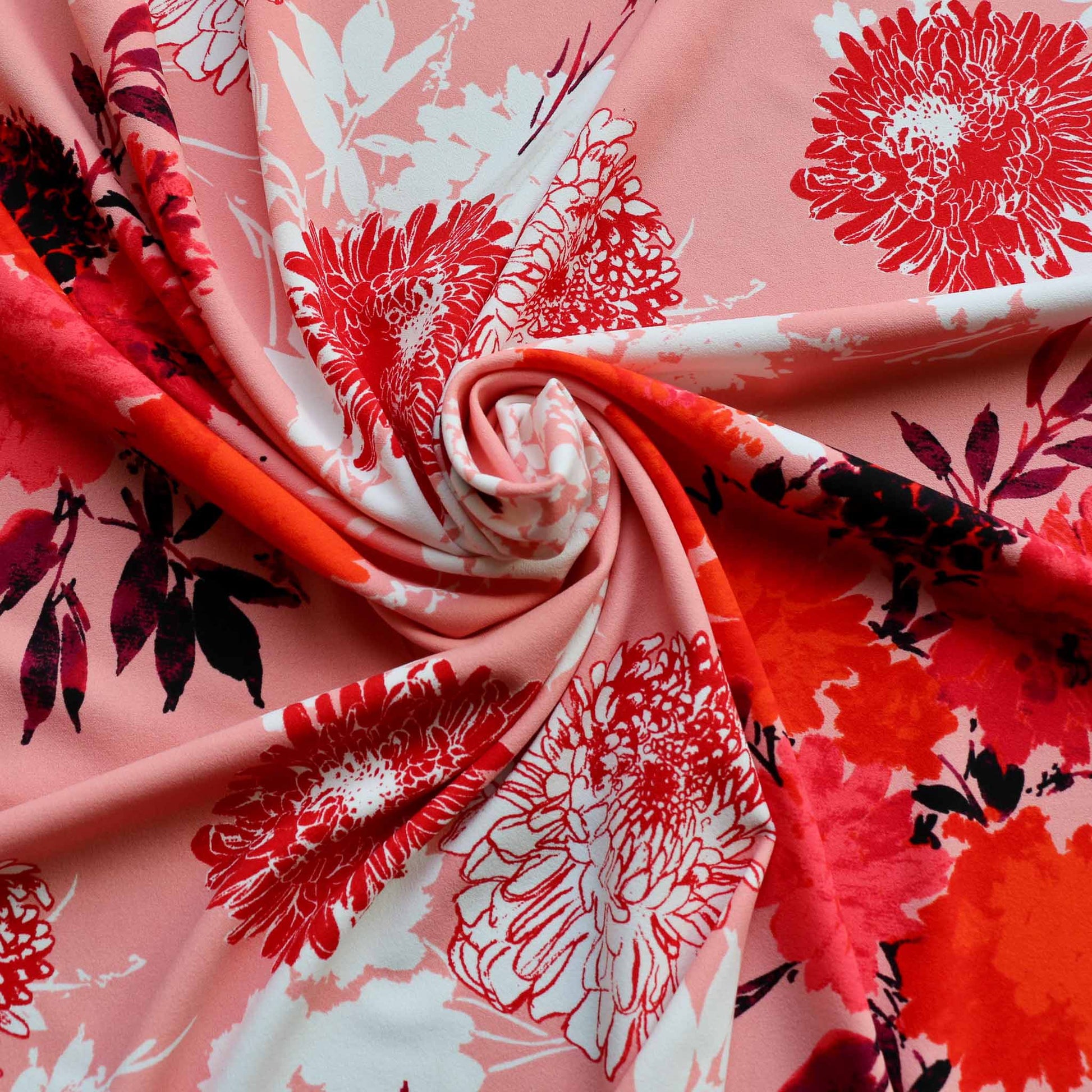 john kaldor dressmaking fabric in pink with red and white floral pattern