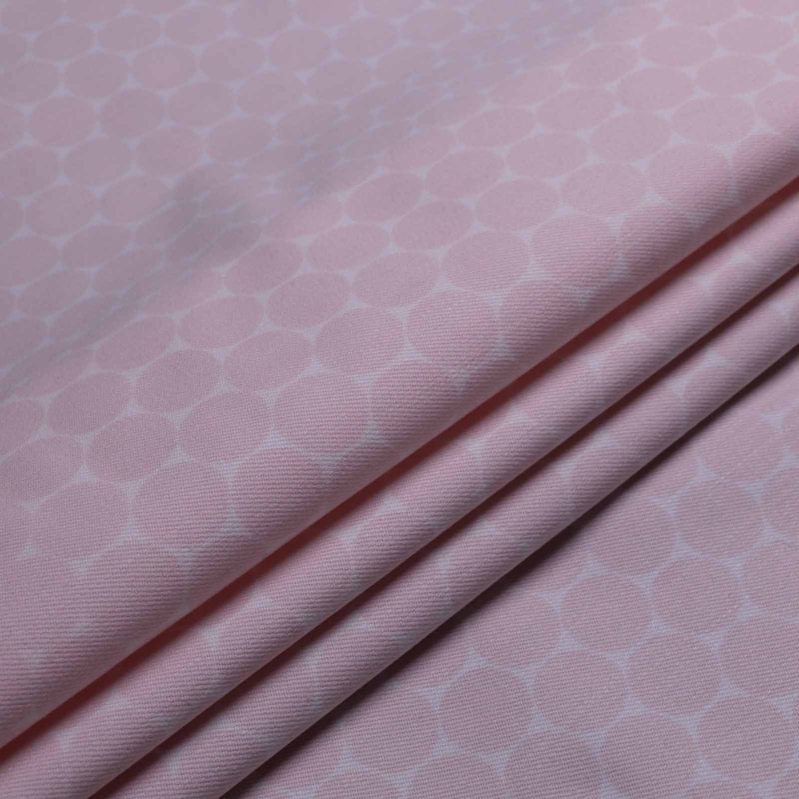 folded pale pink dot pattern on white stretchy cotton twill dressmaking fabric