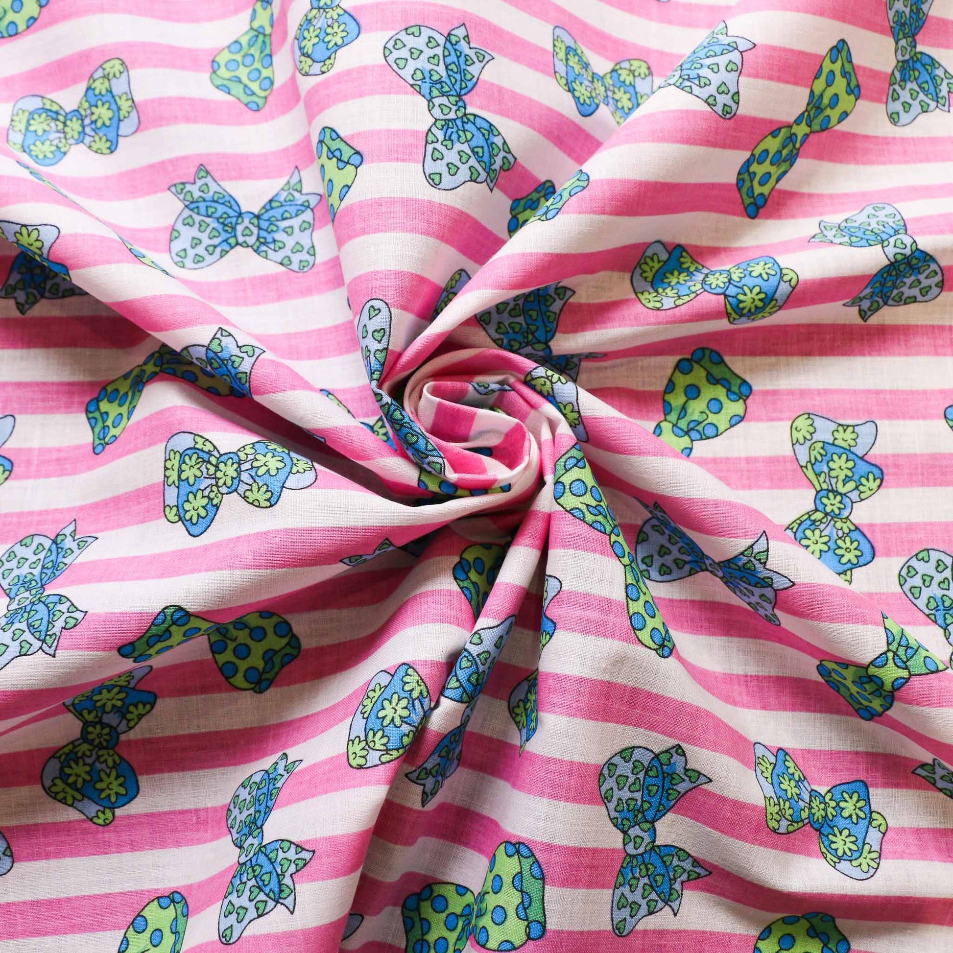 deadstock cotton retro fabric from cloth control Brighton with pink and white stripes and bow tie print