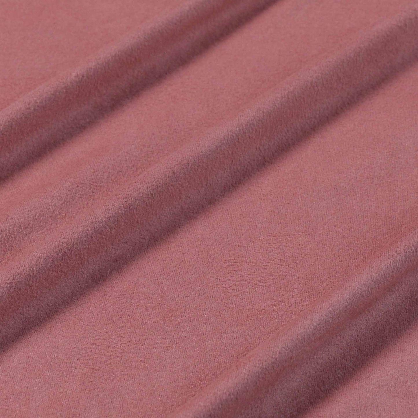 pink stretchy suedette dressmaking fabric with scalloped edge