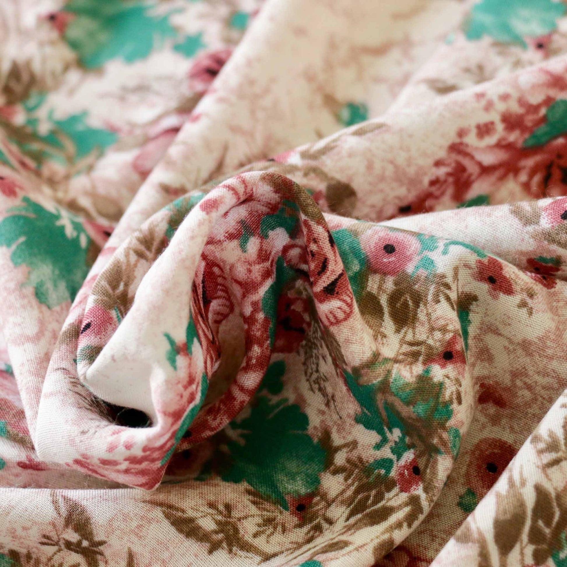 classical floral pattern in turquoise on dusty pink viscose challis dressmaking rayon fabric