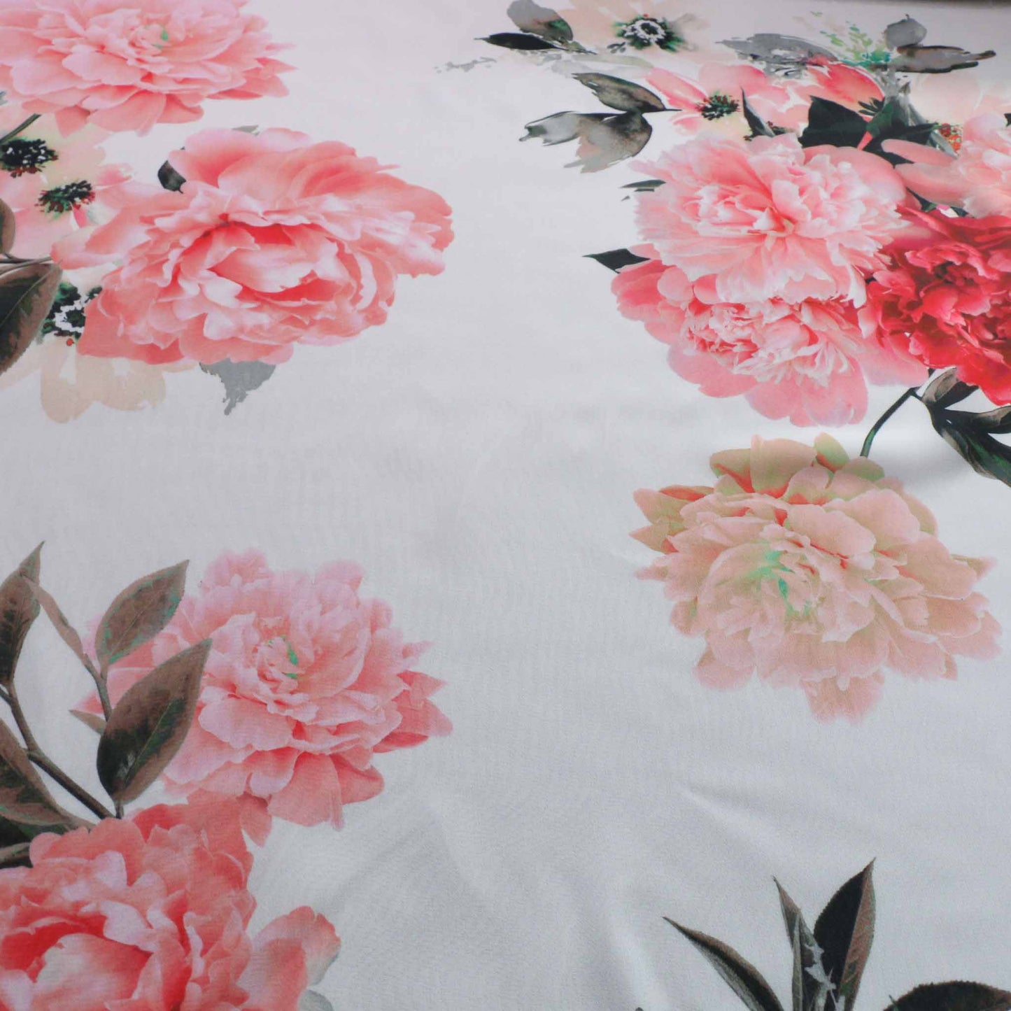 white chiffon dressmaking fabric with pink floral roses design