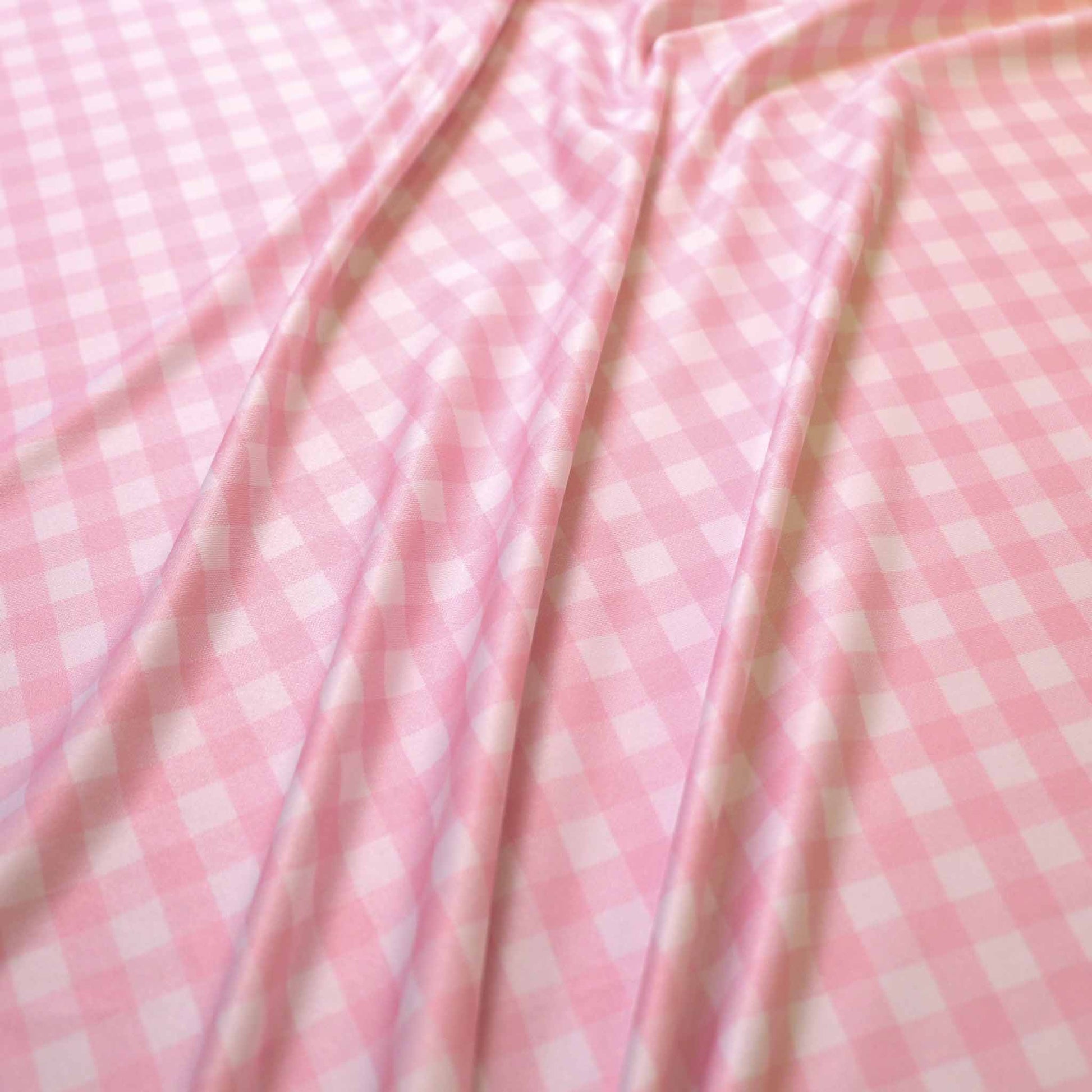 stretchy lycra jersey dressmaking fabric in pink and white gingham print