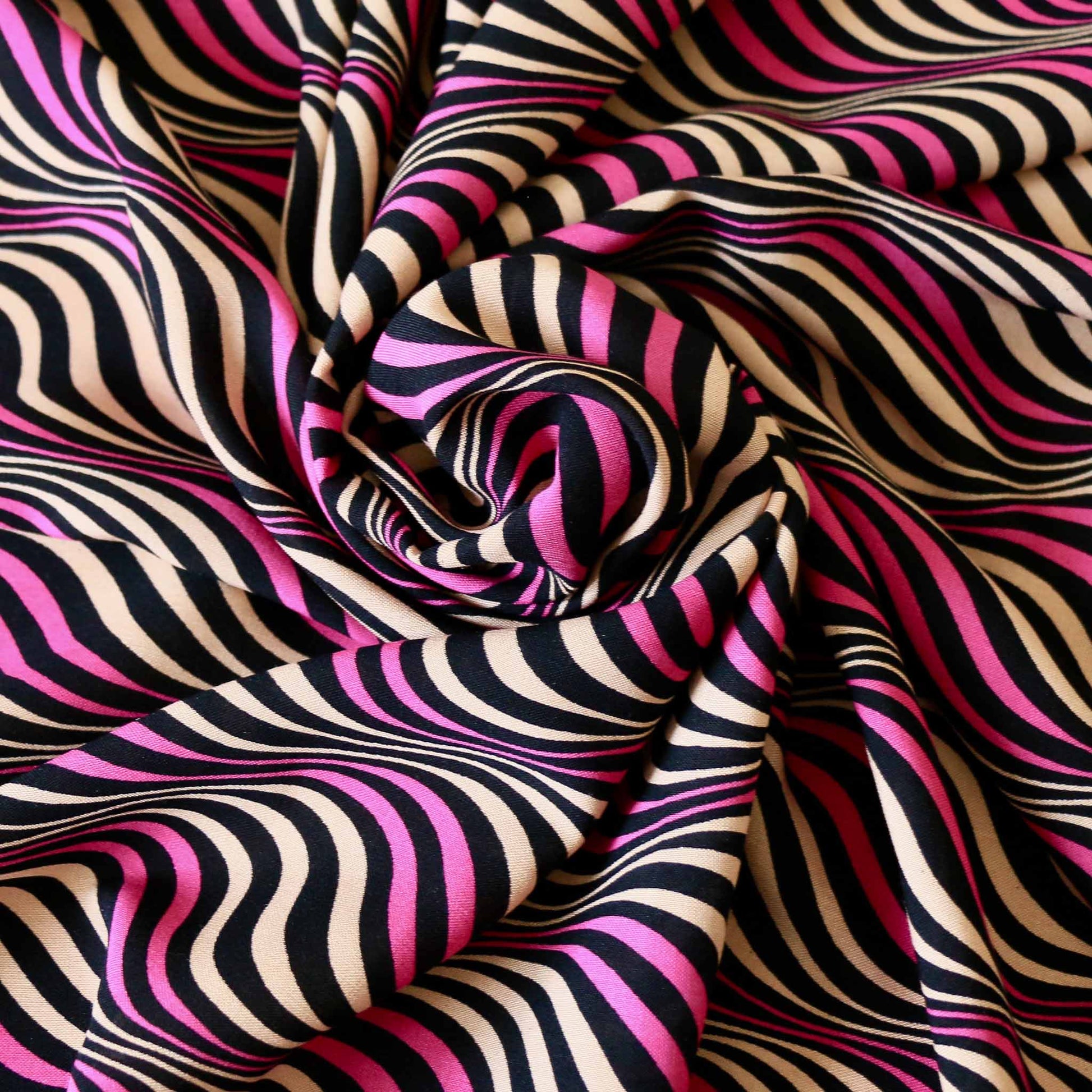 wavey striped viscose challis dressmaking rayon fabric in beige and purple on black