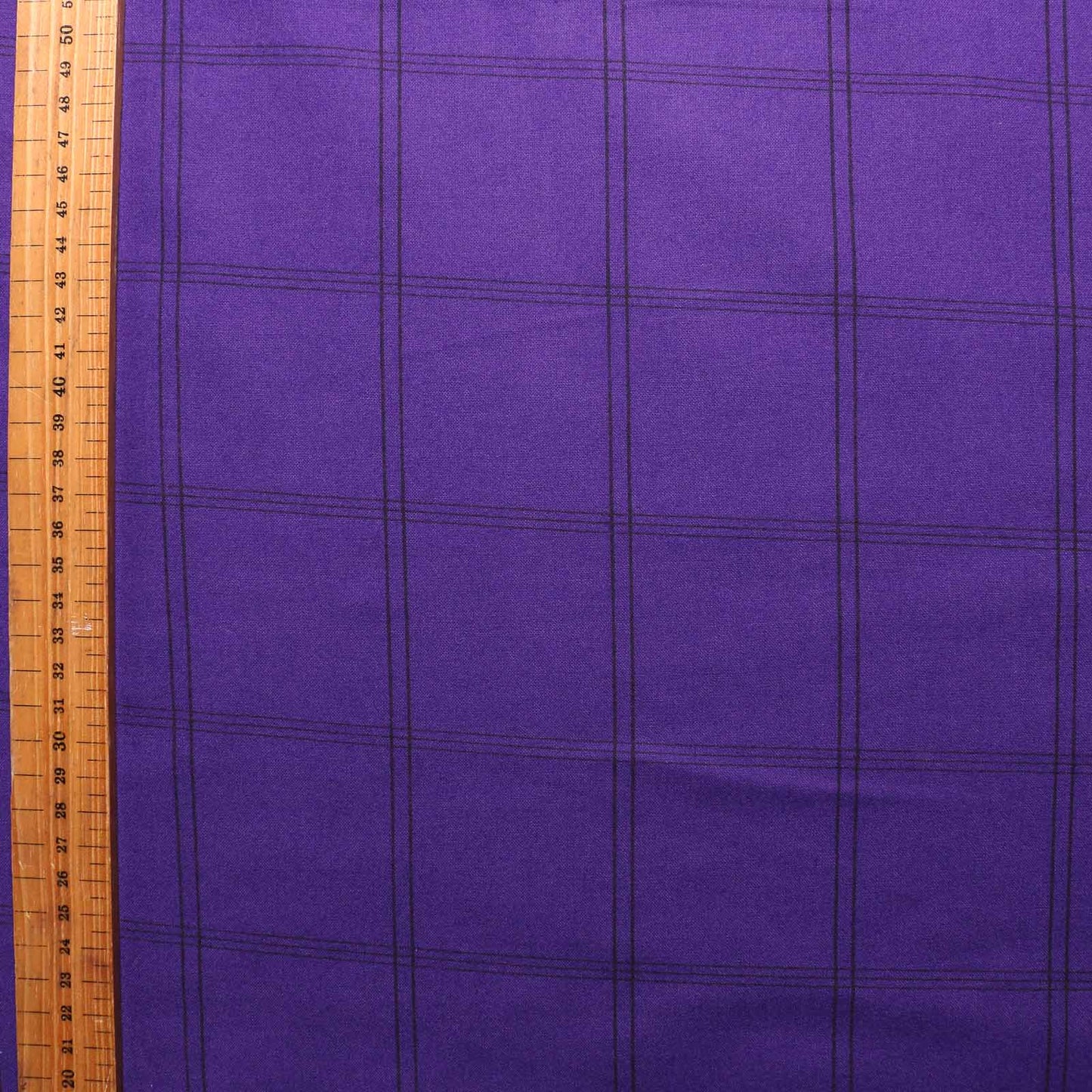 metre brushed cotton dressmaking fabric with purple and black check design