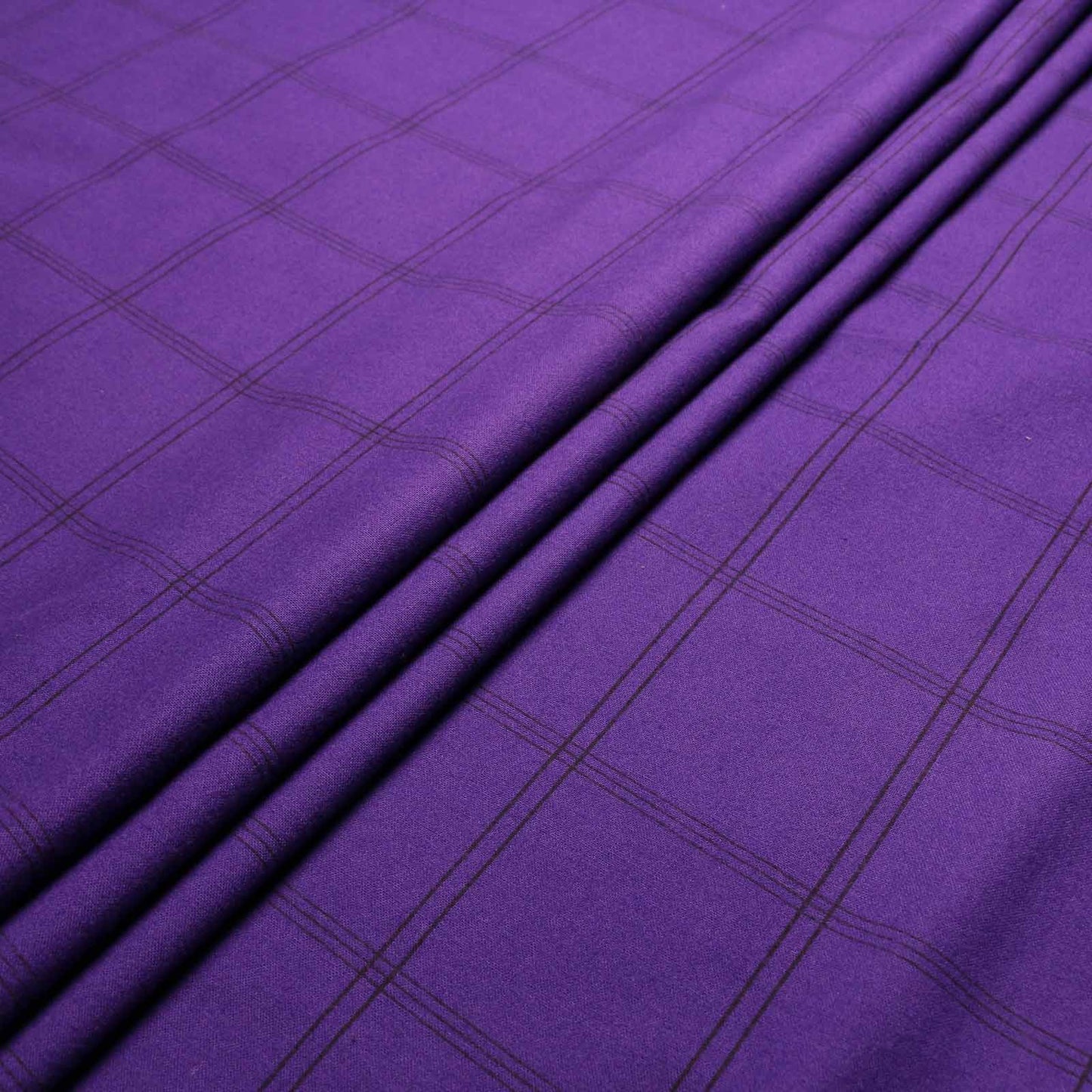 folded purple and black check pattern brushed cotton dressmaking fabric