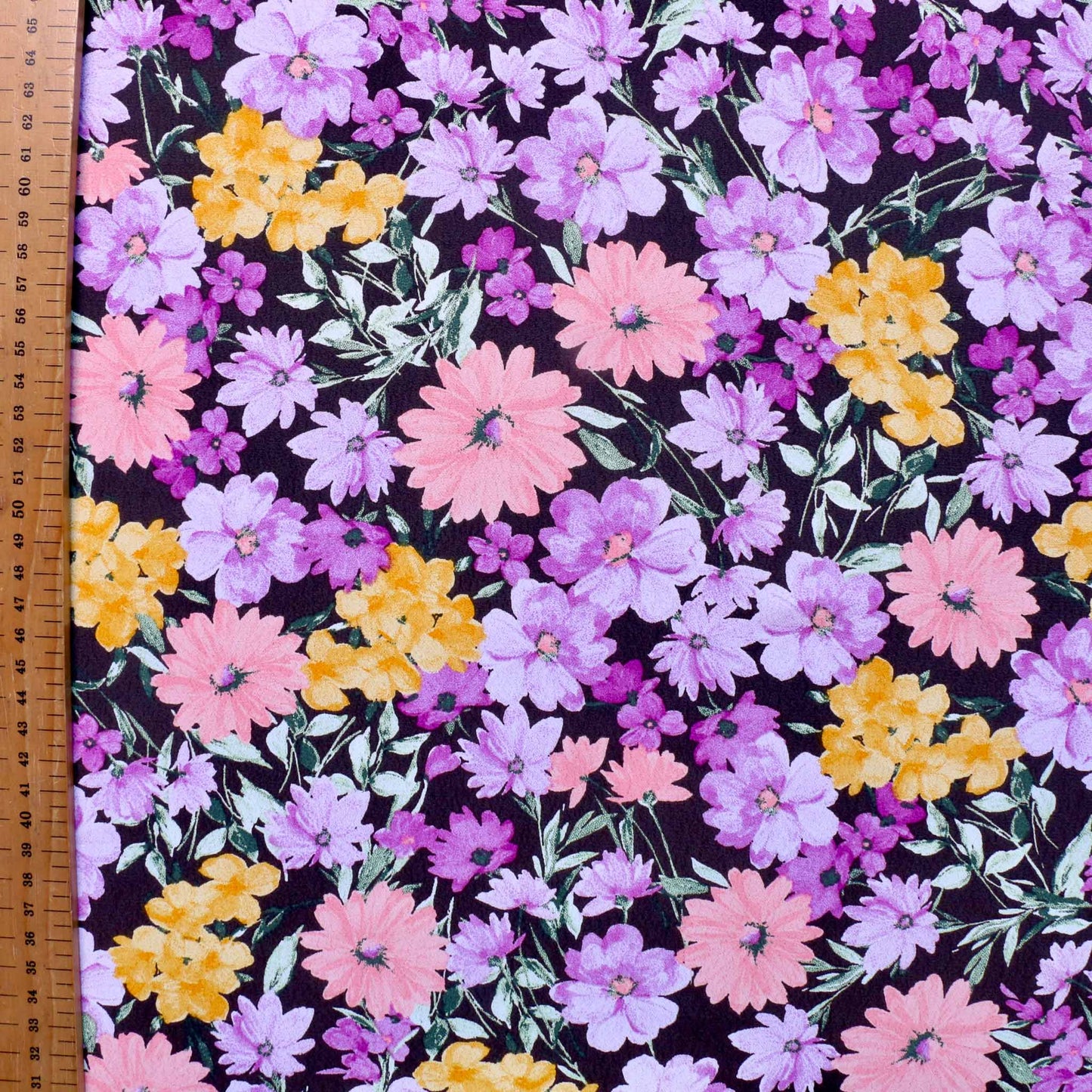 metre crepe de chine dressmaking fabric with floral purple and lilac flower design