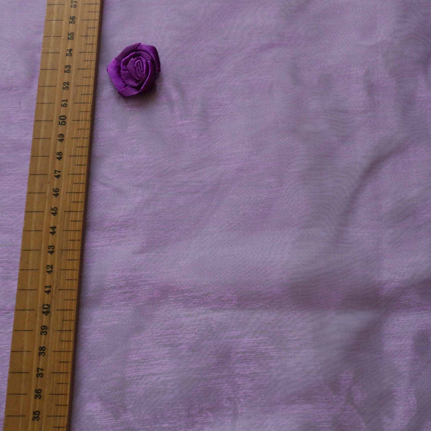 pale purple organza dressmaking fabric with purple rose embellishment