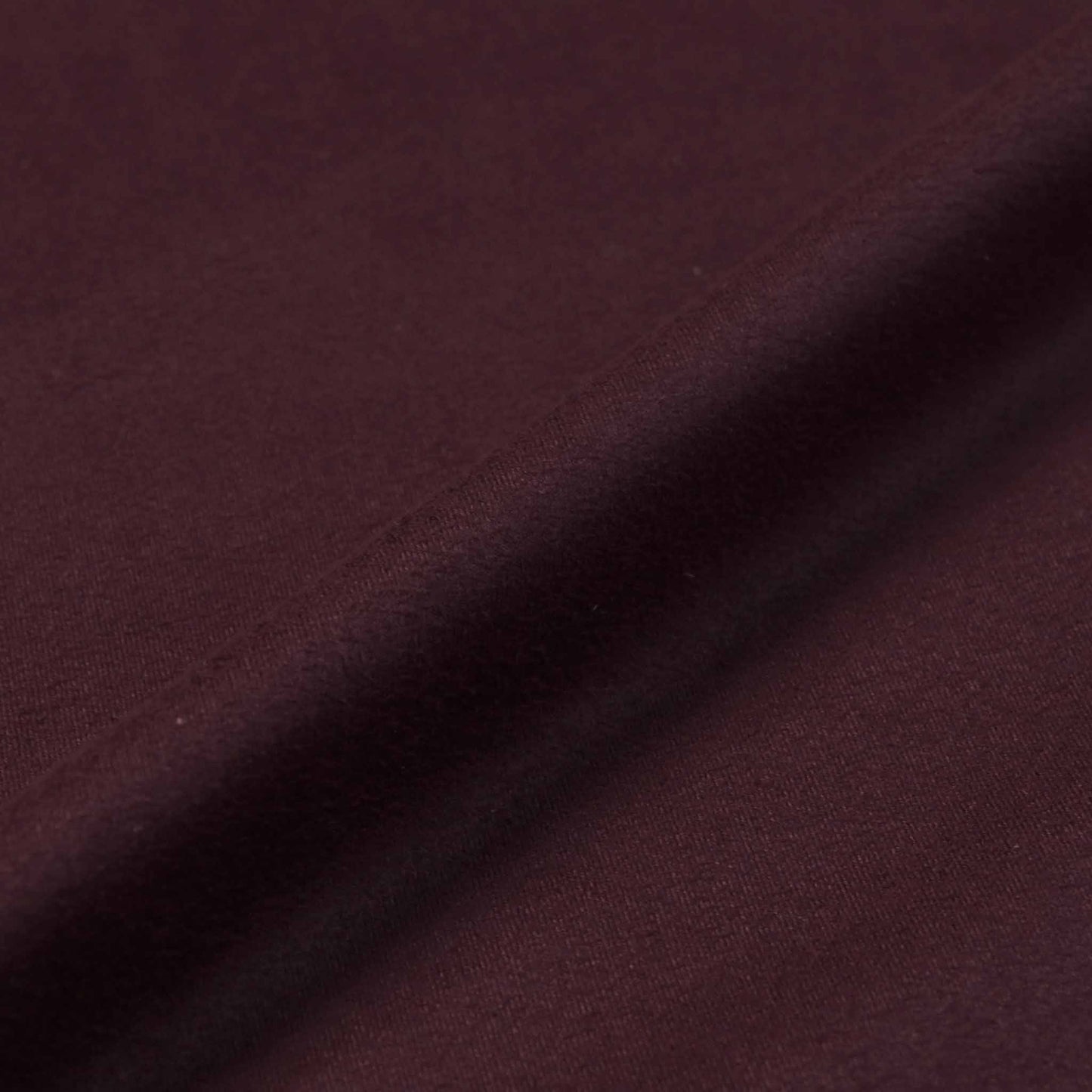 stretchy suedette dressmaking fabric in plum purple colour
