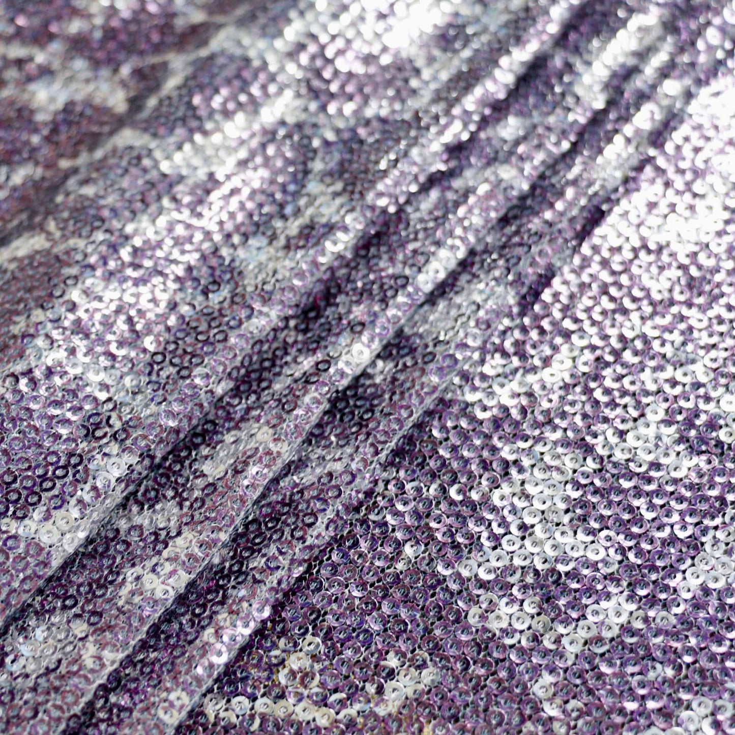 animal skin design sequin dressmaking fabric in silver and purple