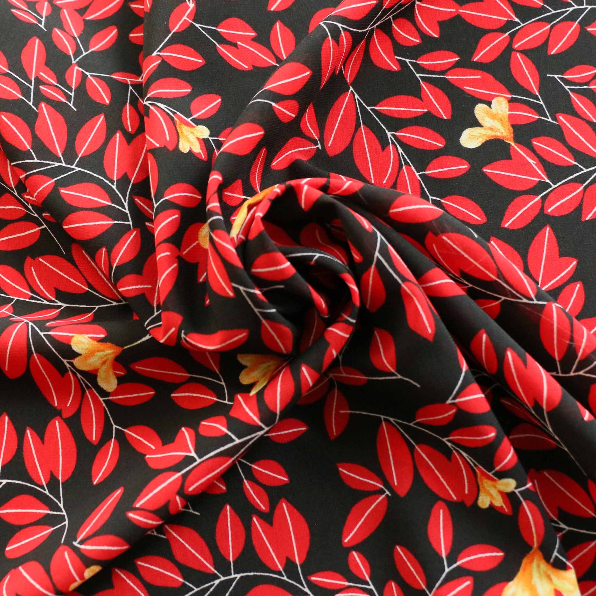 red leaf print on black chiffon polyester dressmaking fabric