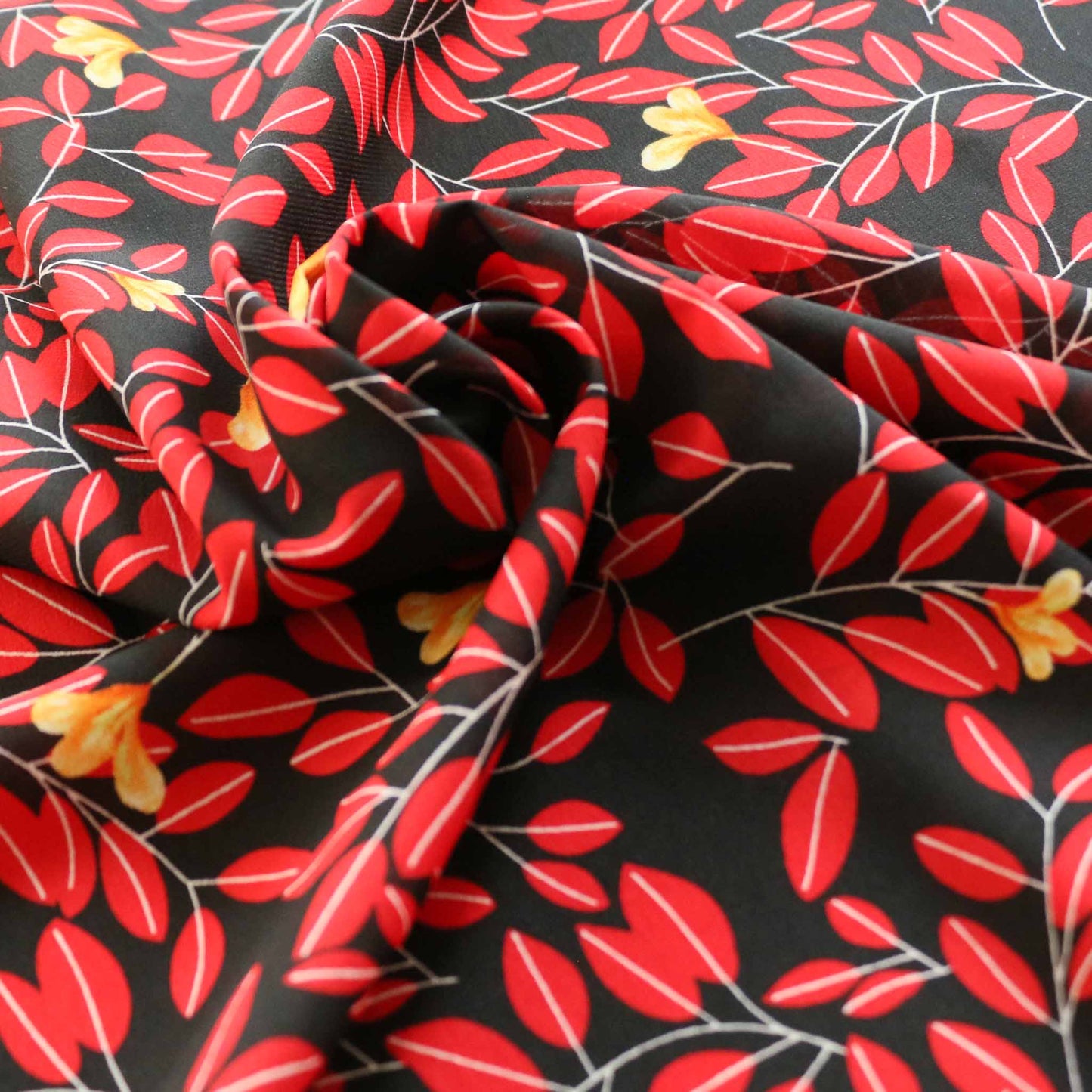 red leaf print on black dressmaking stretchy chiffon fabric