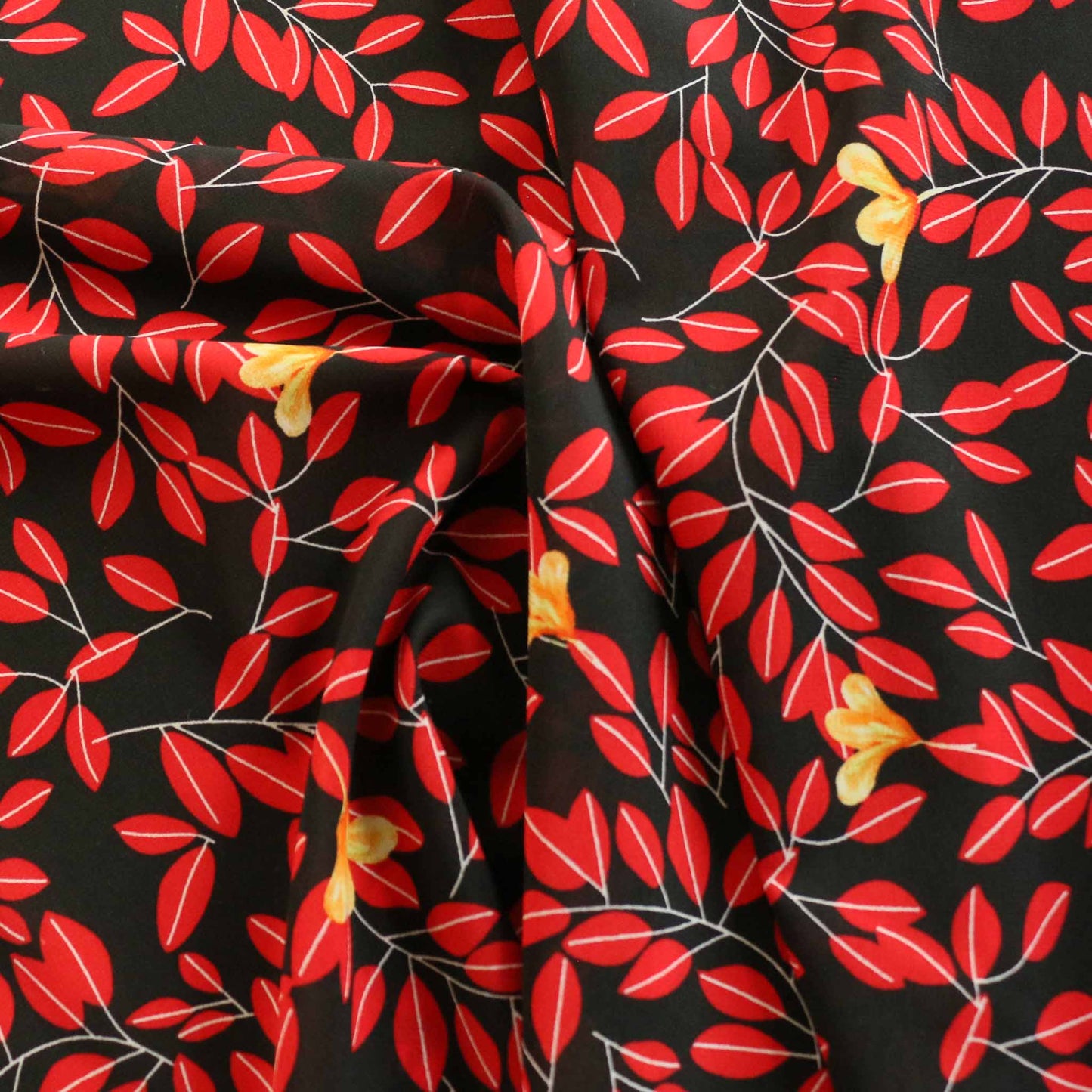 black stretchy chiffon dressmaking fabric with red leaf print