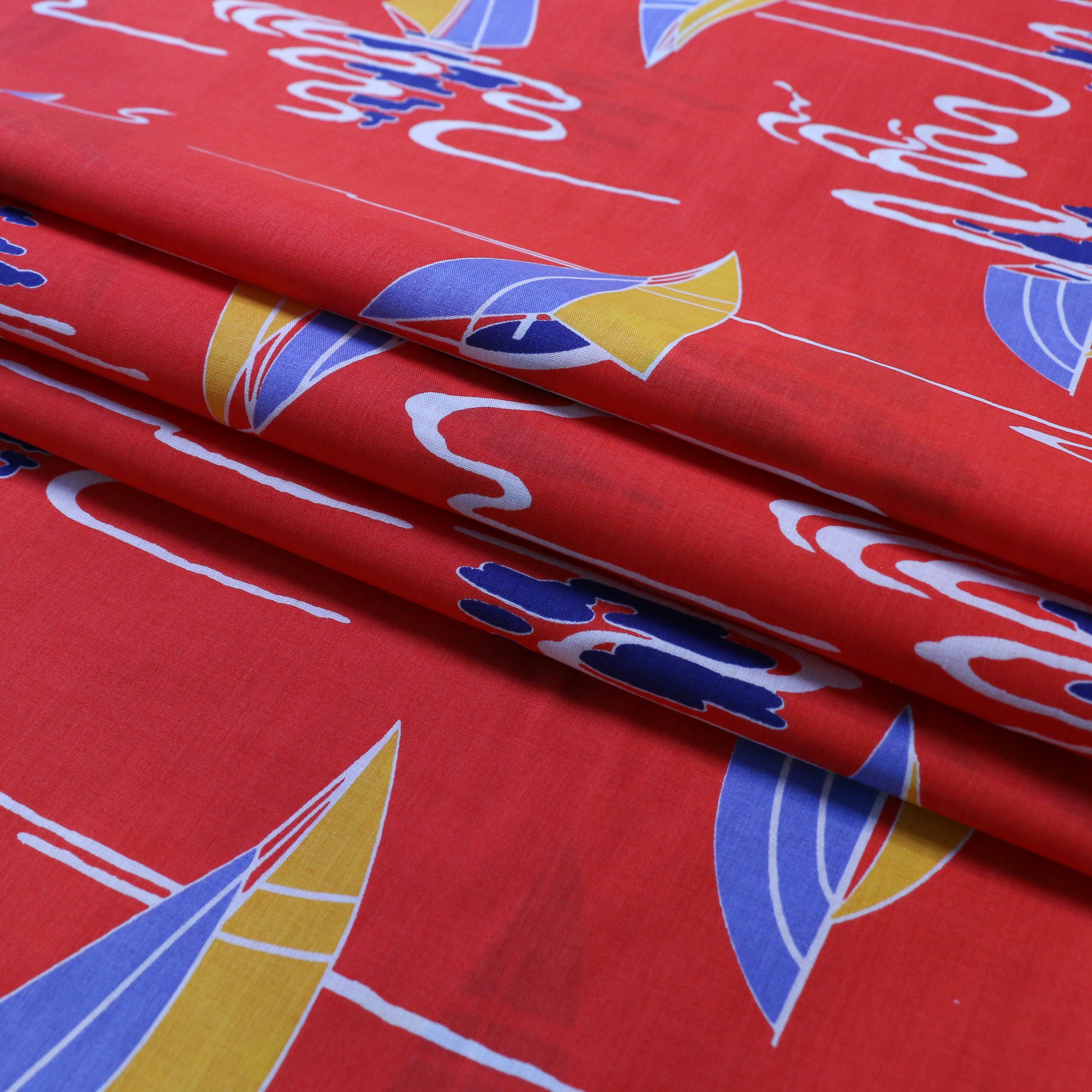 red vintage cotton dressmaking sustainable deadstock fabric with blue and yellow nautical print
