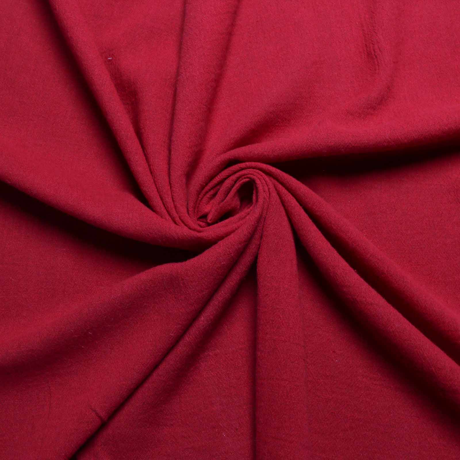 close up of crinkle cotton gauze dressmaking fabric in plain red