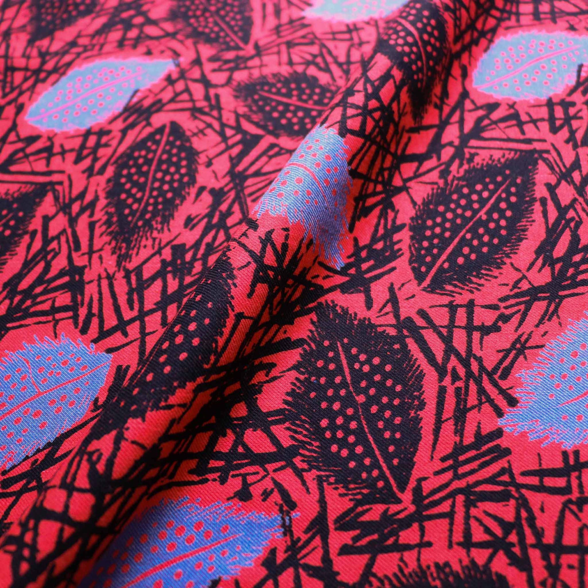 sustainable dressmaking fabric in red cotton with leaves print