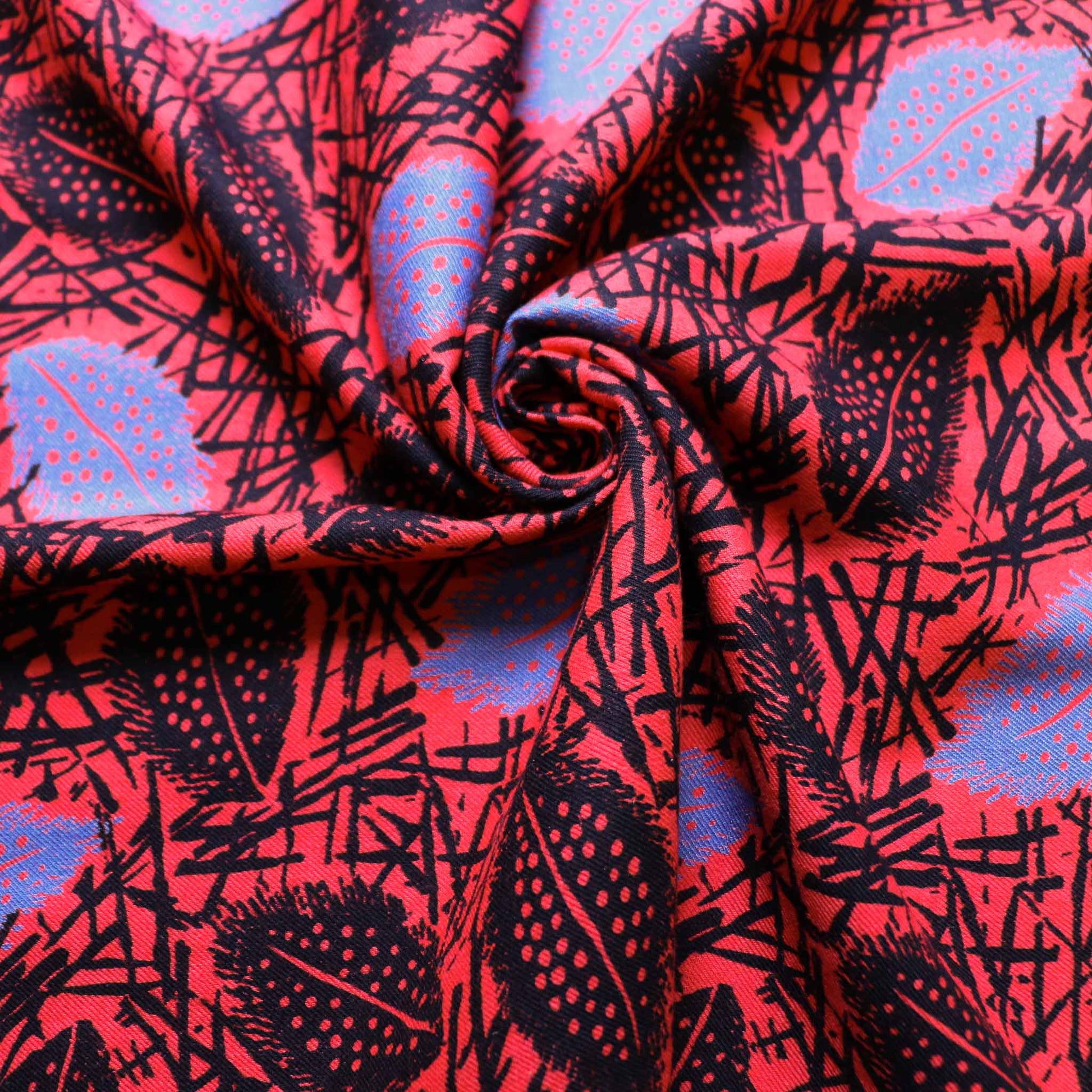 sustainable red vintage design cotton twill dress fabric with printed leaves design in blue and black
