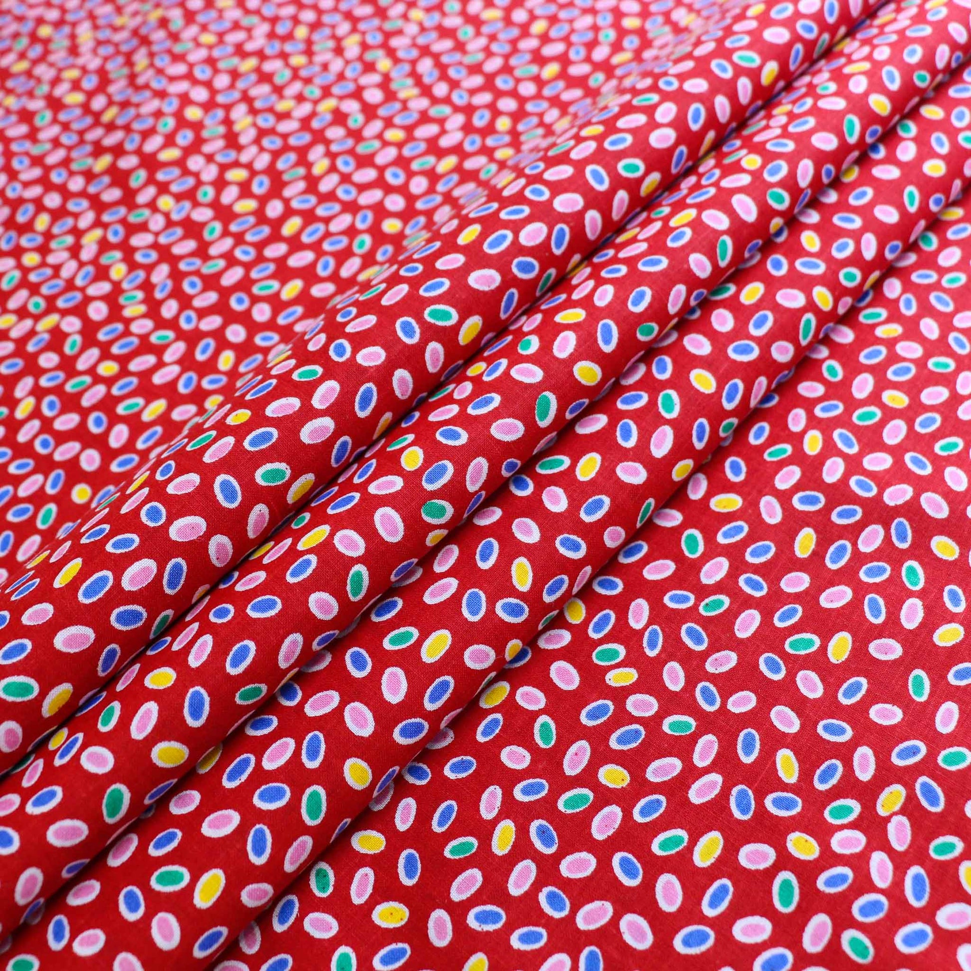 folded red vintage cotton poplin deadstock sustainable fabric with printed dot pattern