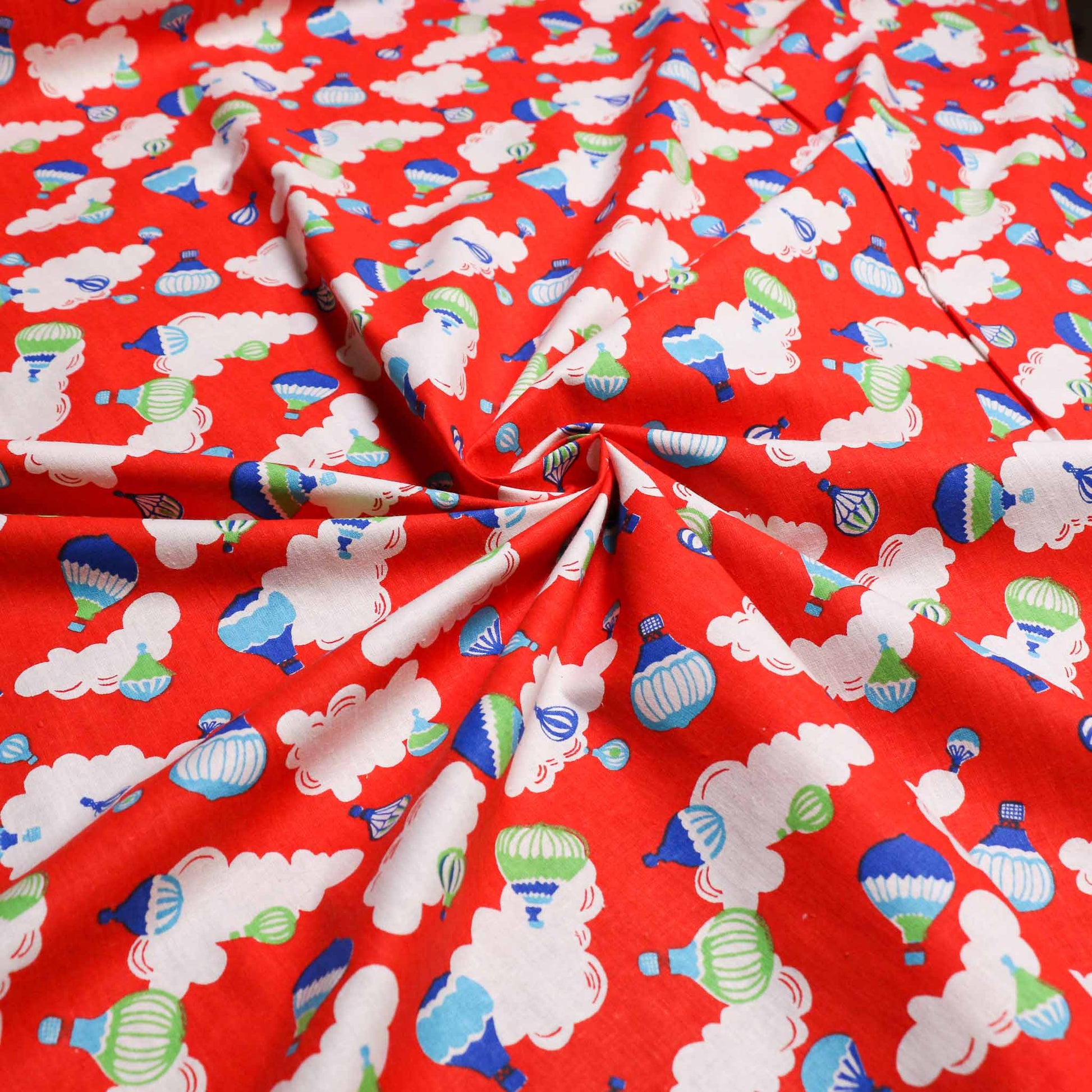 red sustainable retro cotton dressmaking fabric with hot air balloon clouds print